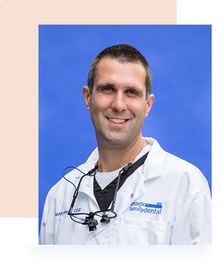 Dr. Nathan Makay smiling in his white dental coat