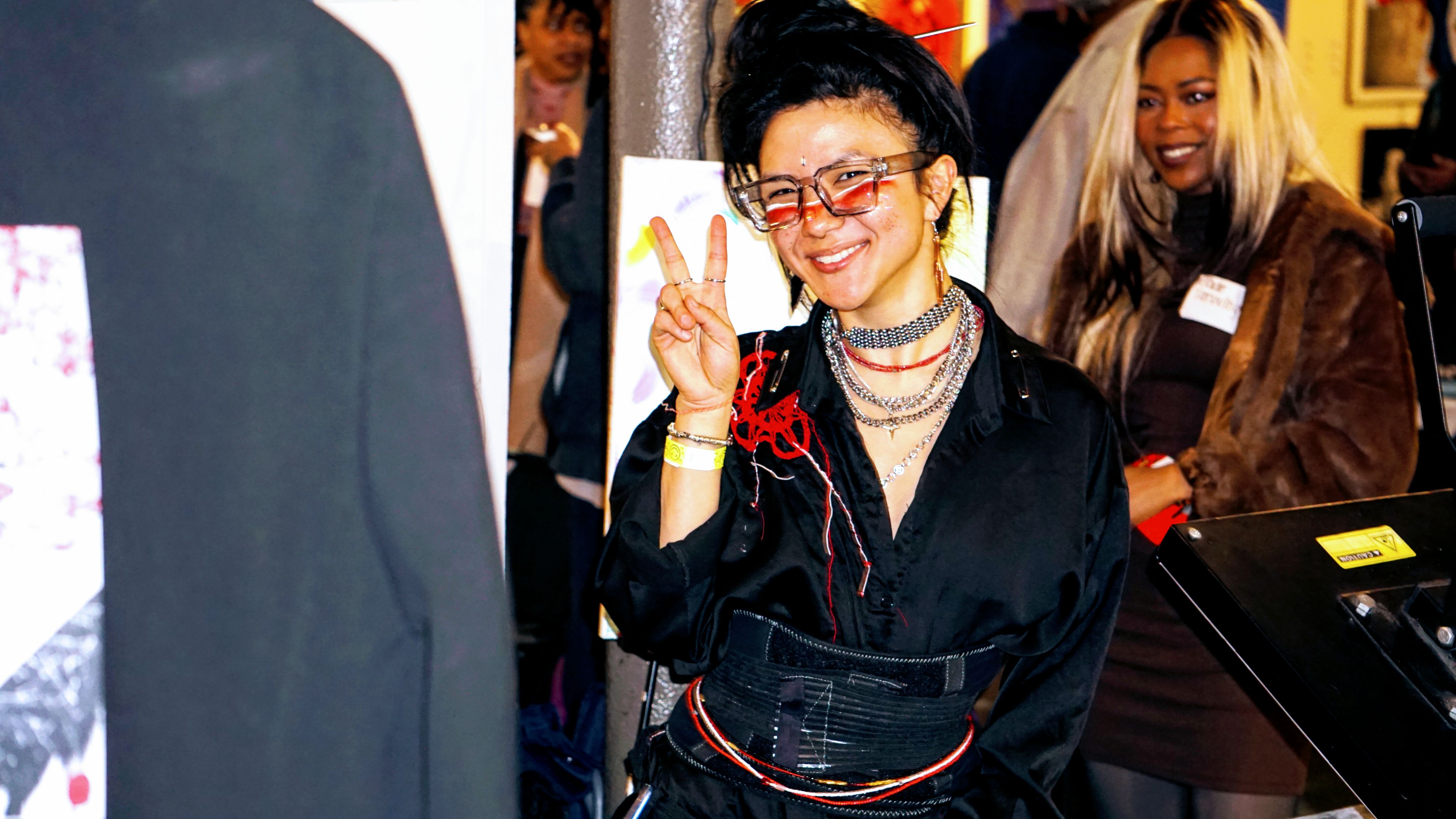 Stylish attendee posing with peace sign