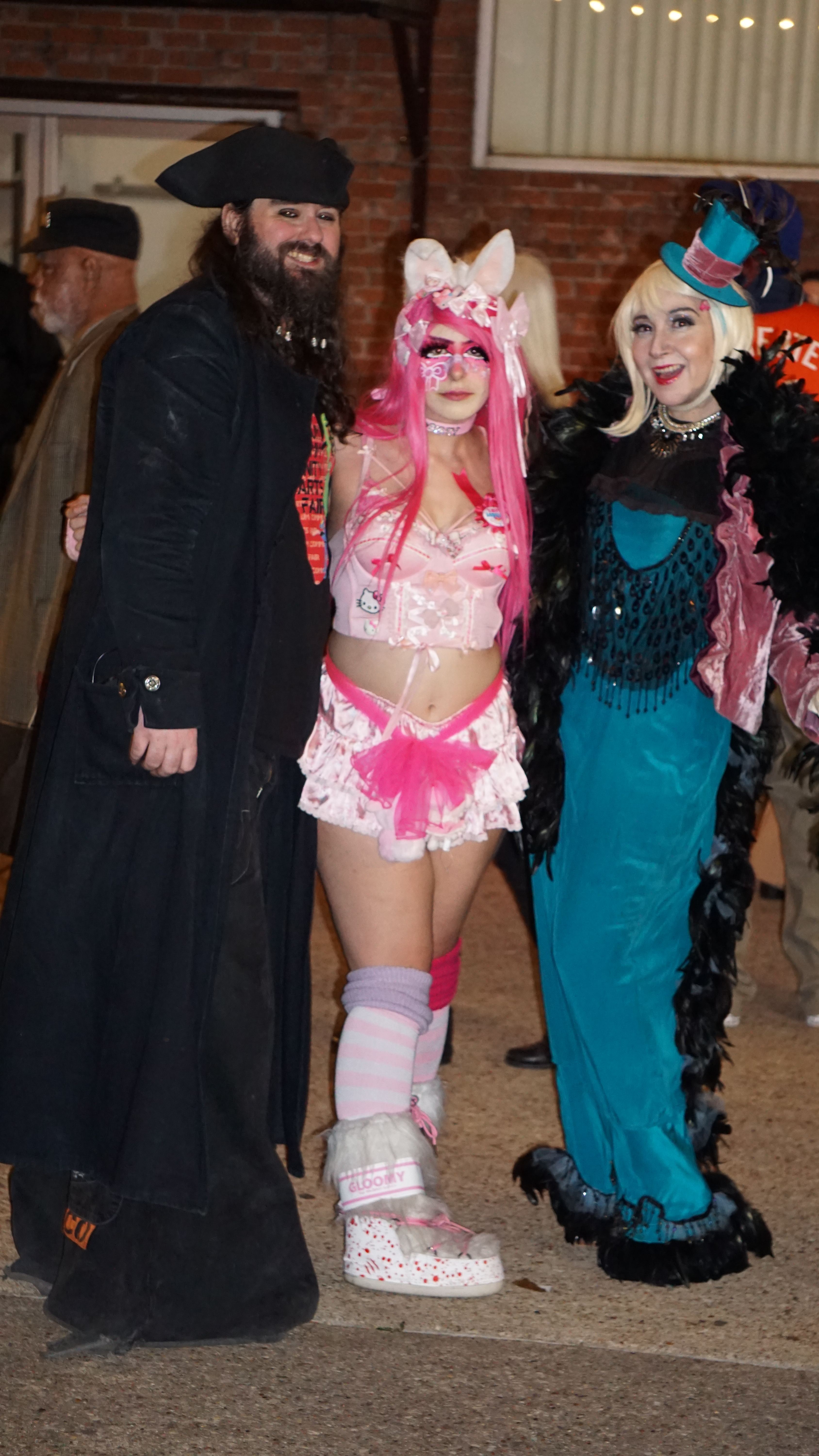 Three cosplayers in creative costumes posing together