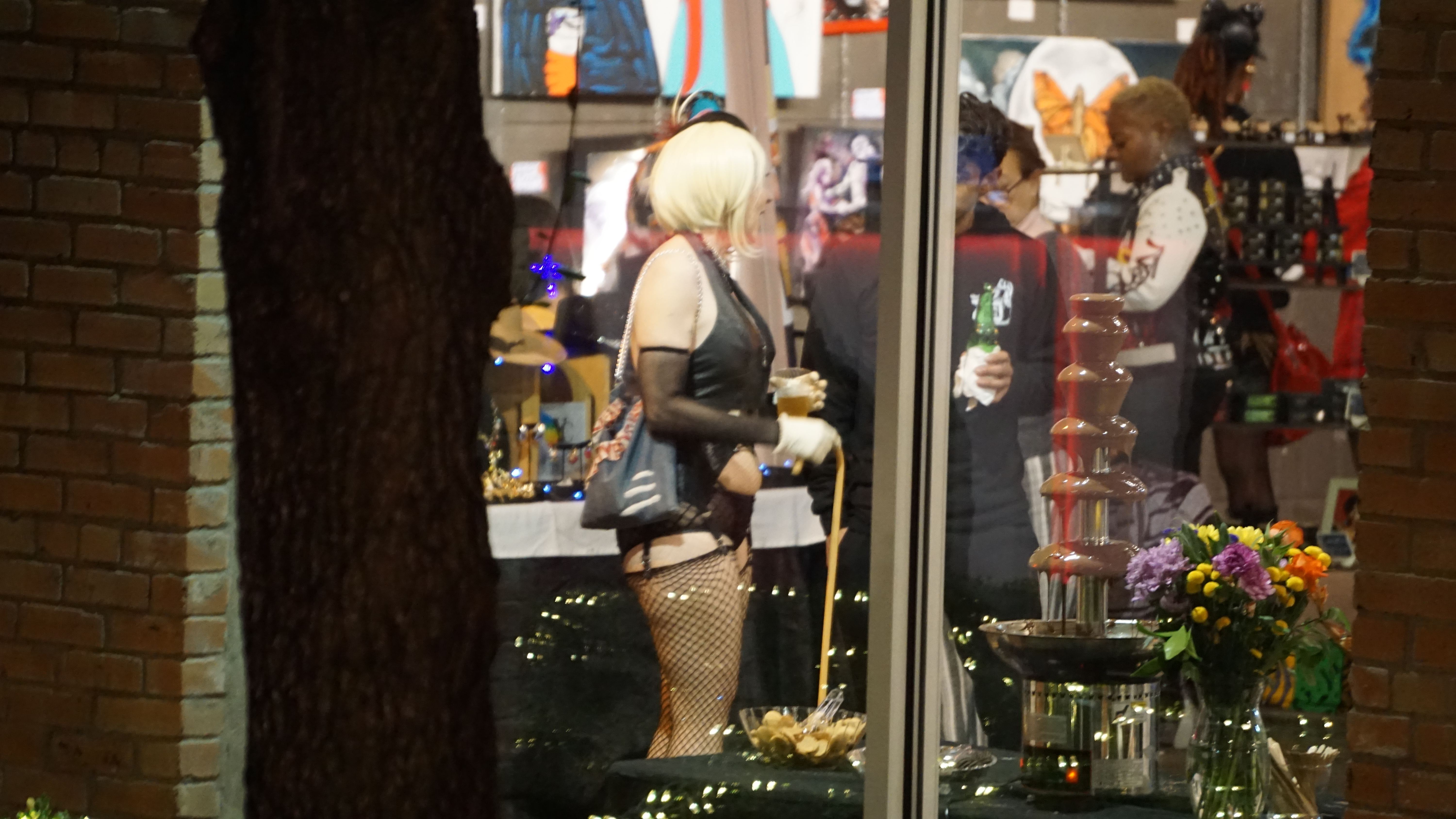 Chocolate fountain with flowers and attendees enjoying event