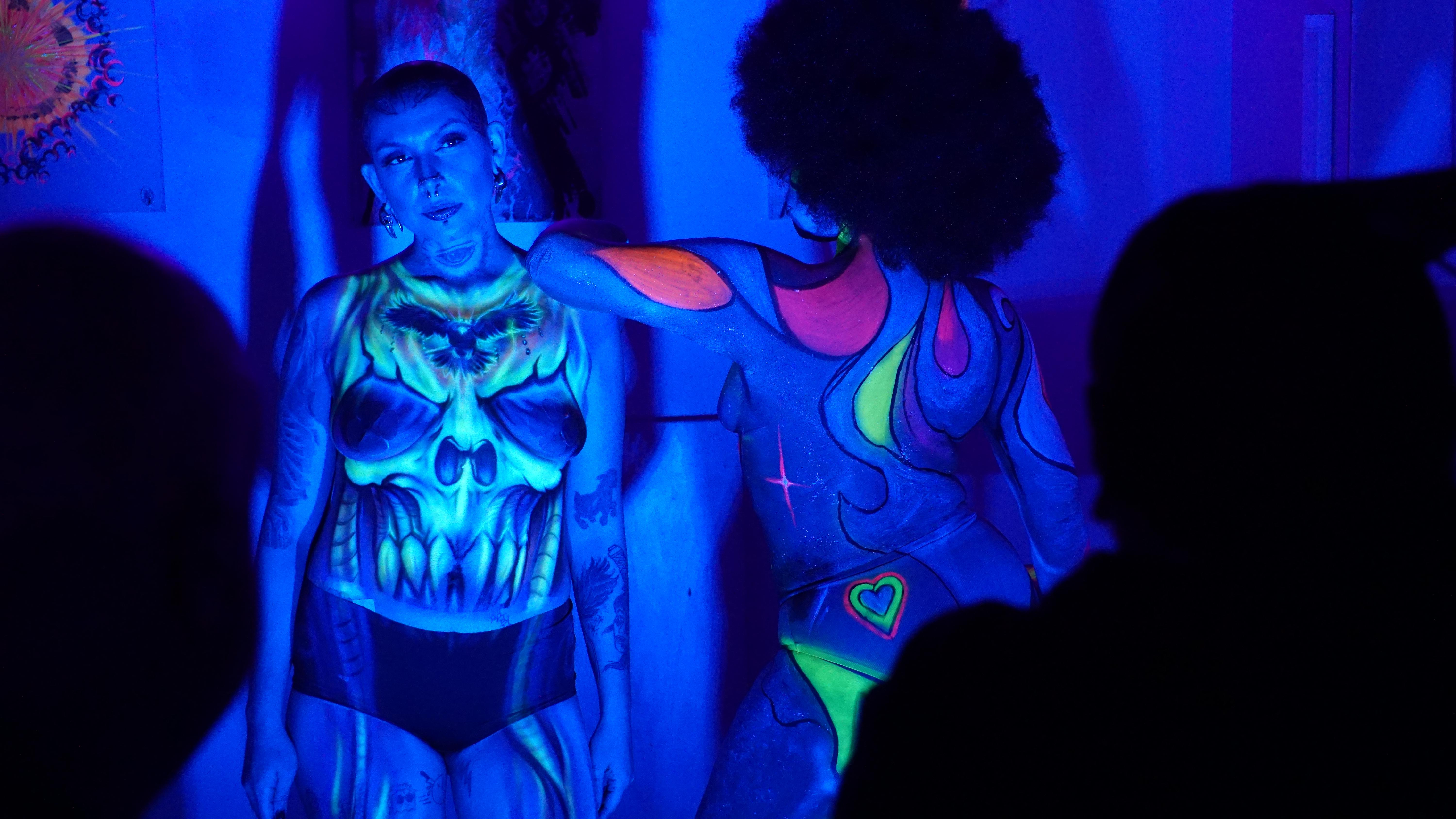 UV body painting performance with glowing art