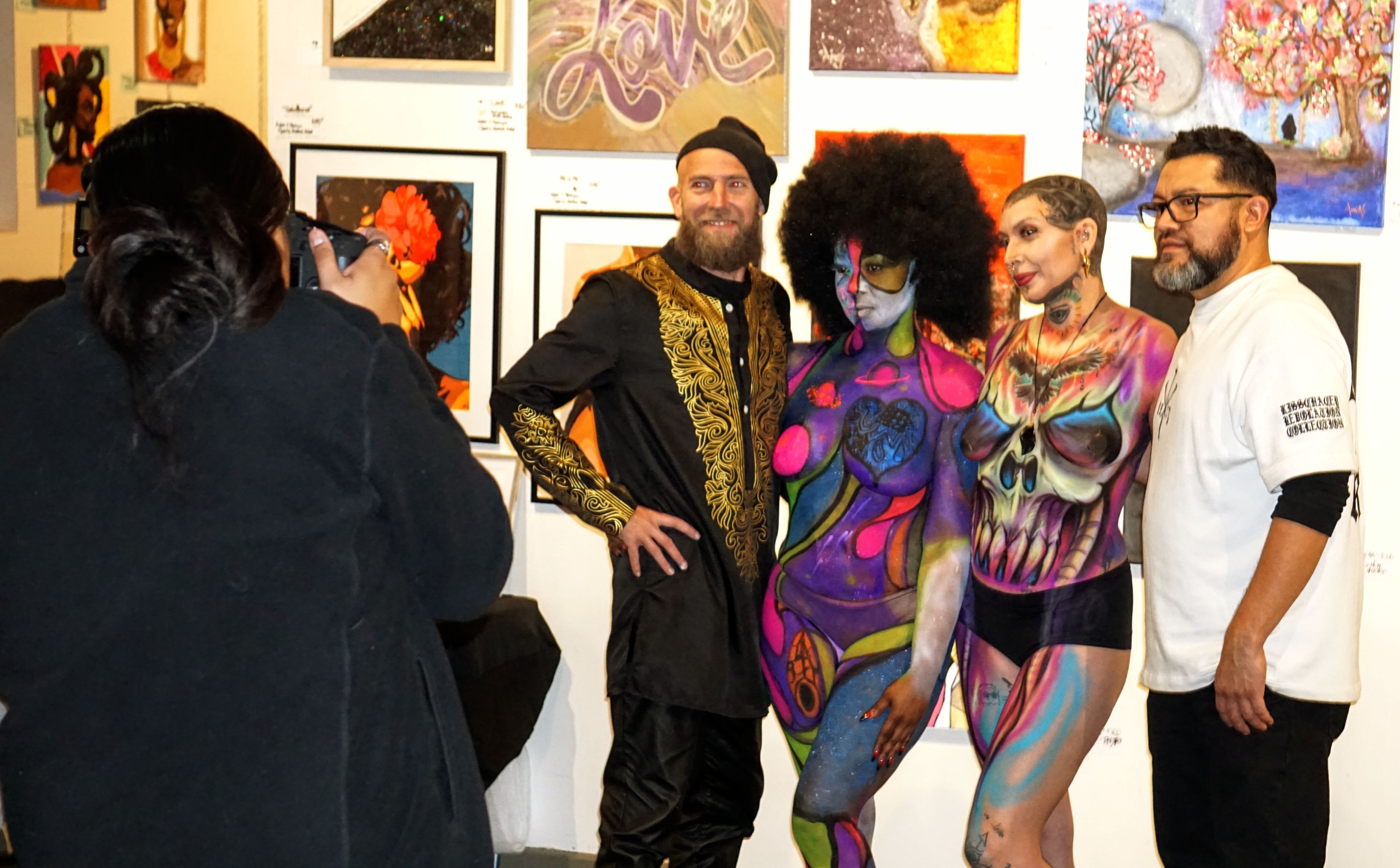 Body painted models posing with artists at Chocolate and Art Show