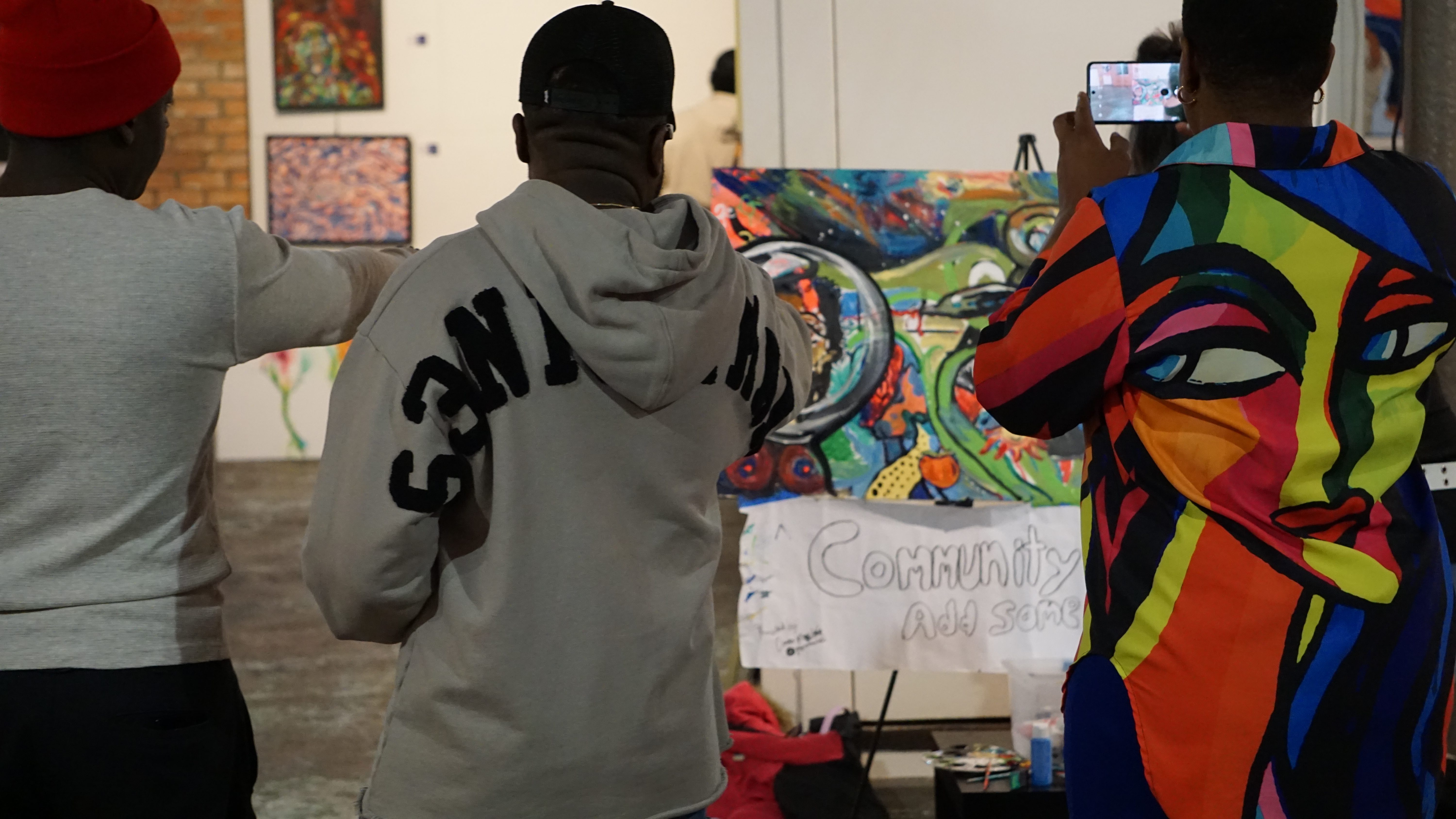 Attendees watching live community painting