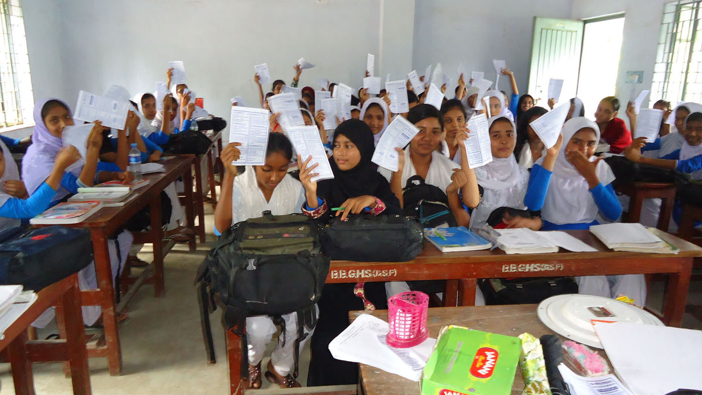 Students in a PRIDE Bangladesh educational program showing their achievements