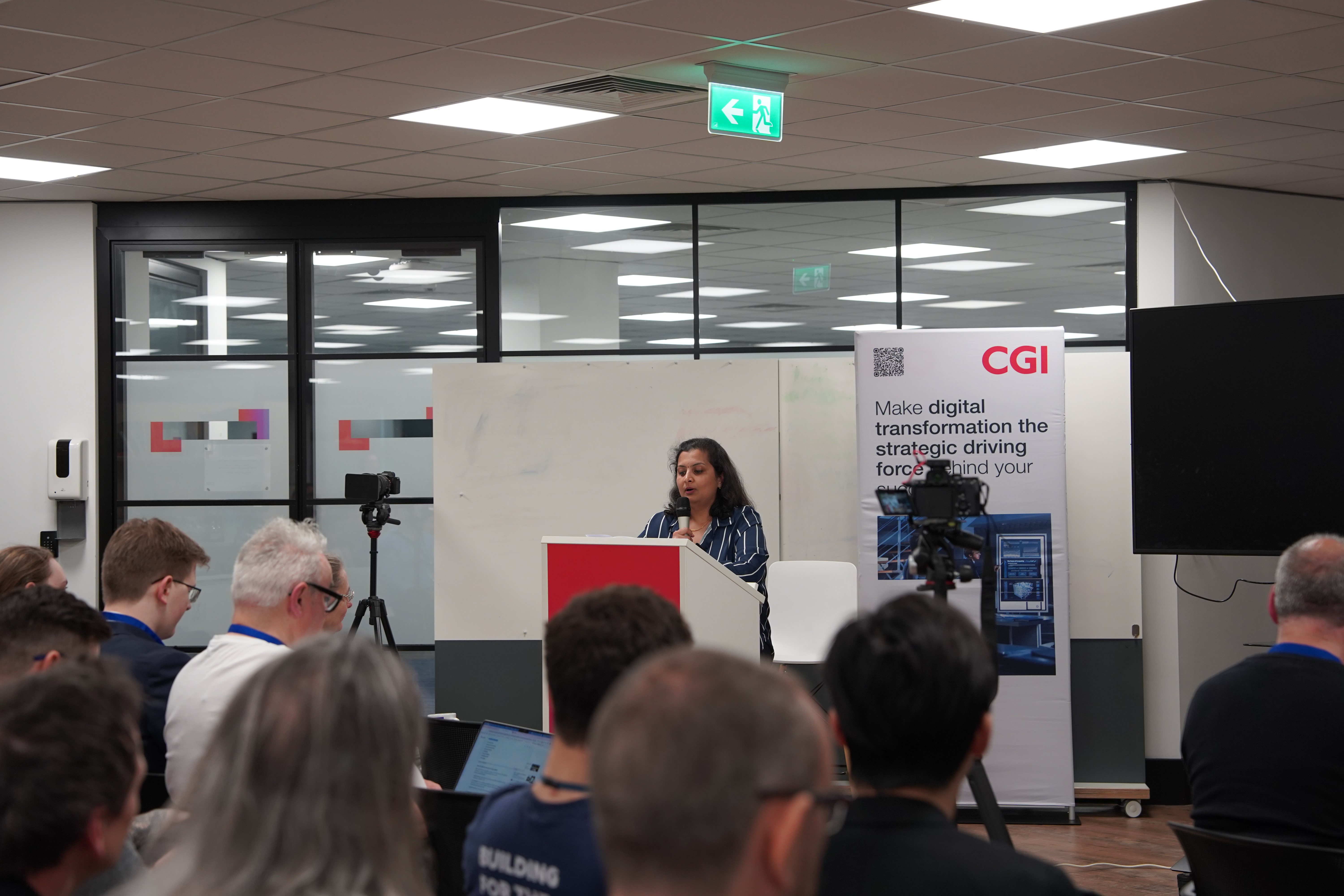 Speaker presenting at CGI-branded podium