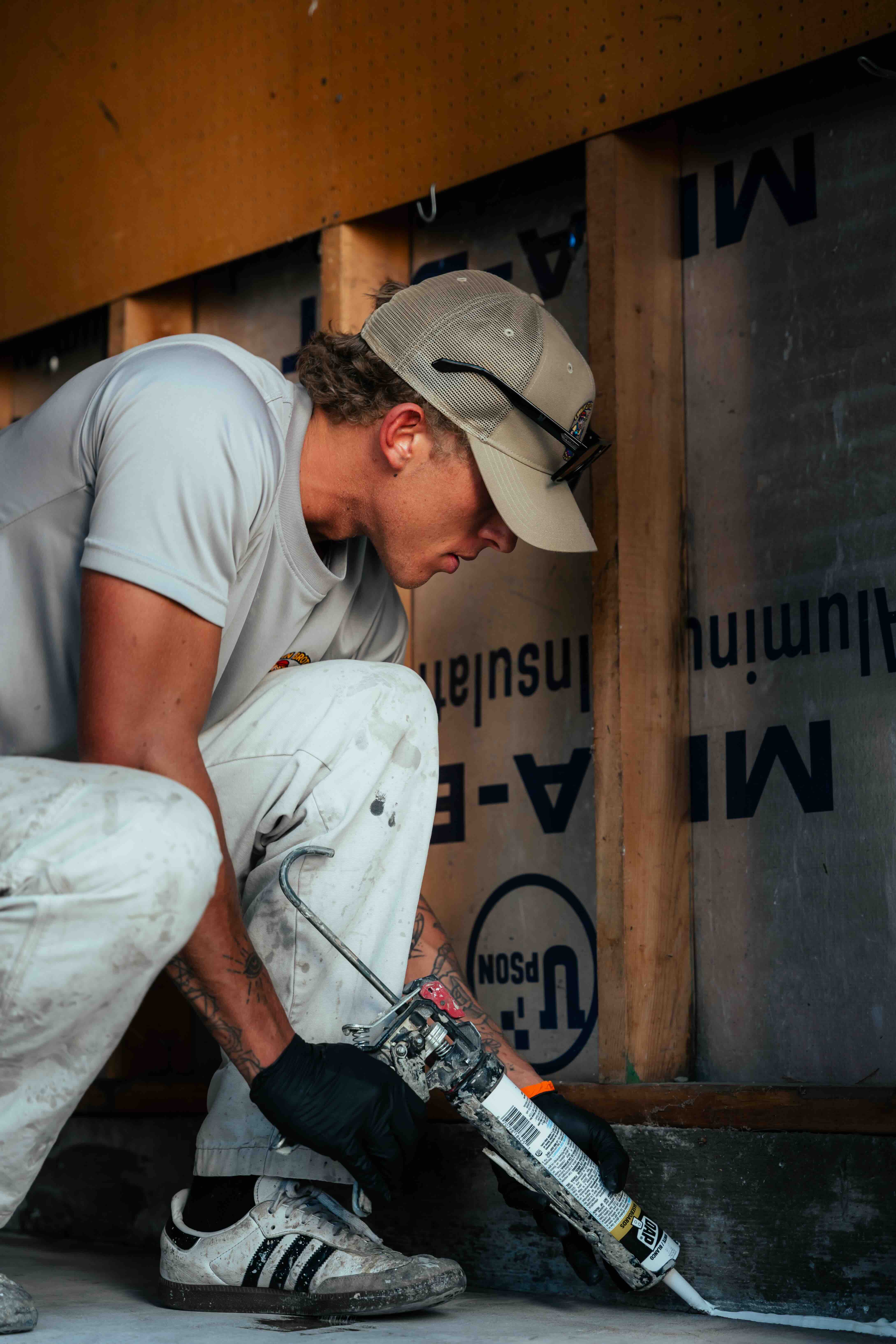 Contractor social media content - flooring installer laying hardwood in residential home