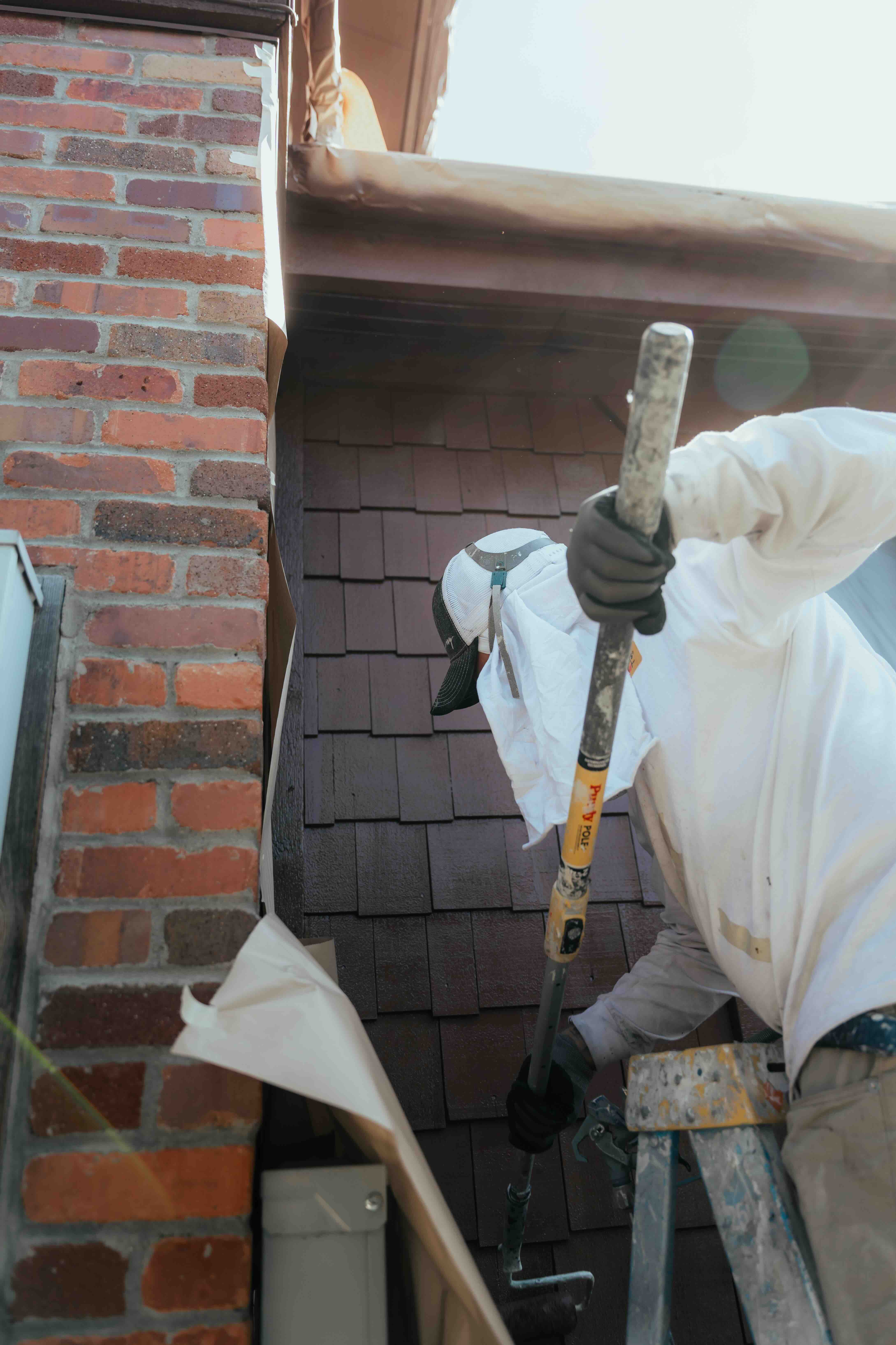 Contractor social media content - holiday lighting installer on roof at dusk