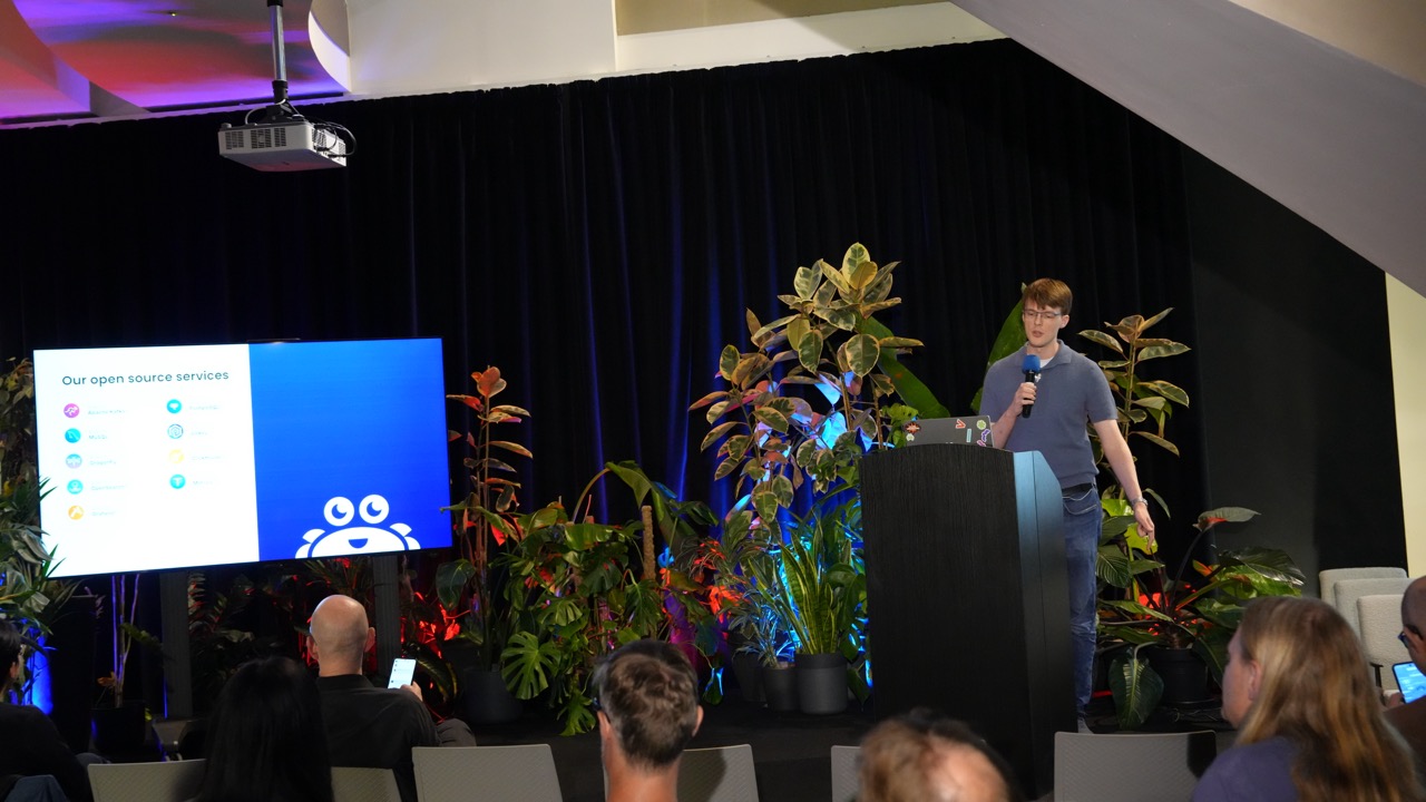 Speaker presenting open source services on the BrainStation main stage