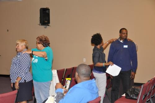 Dr. Mukaia engaging with community members at event