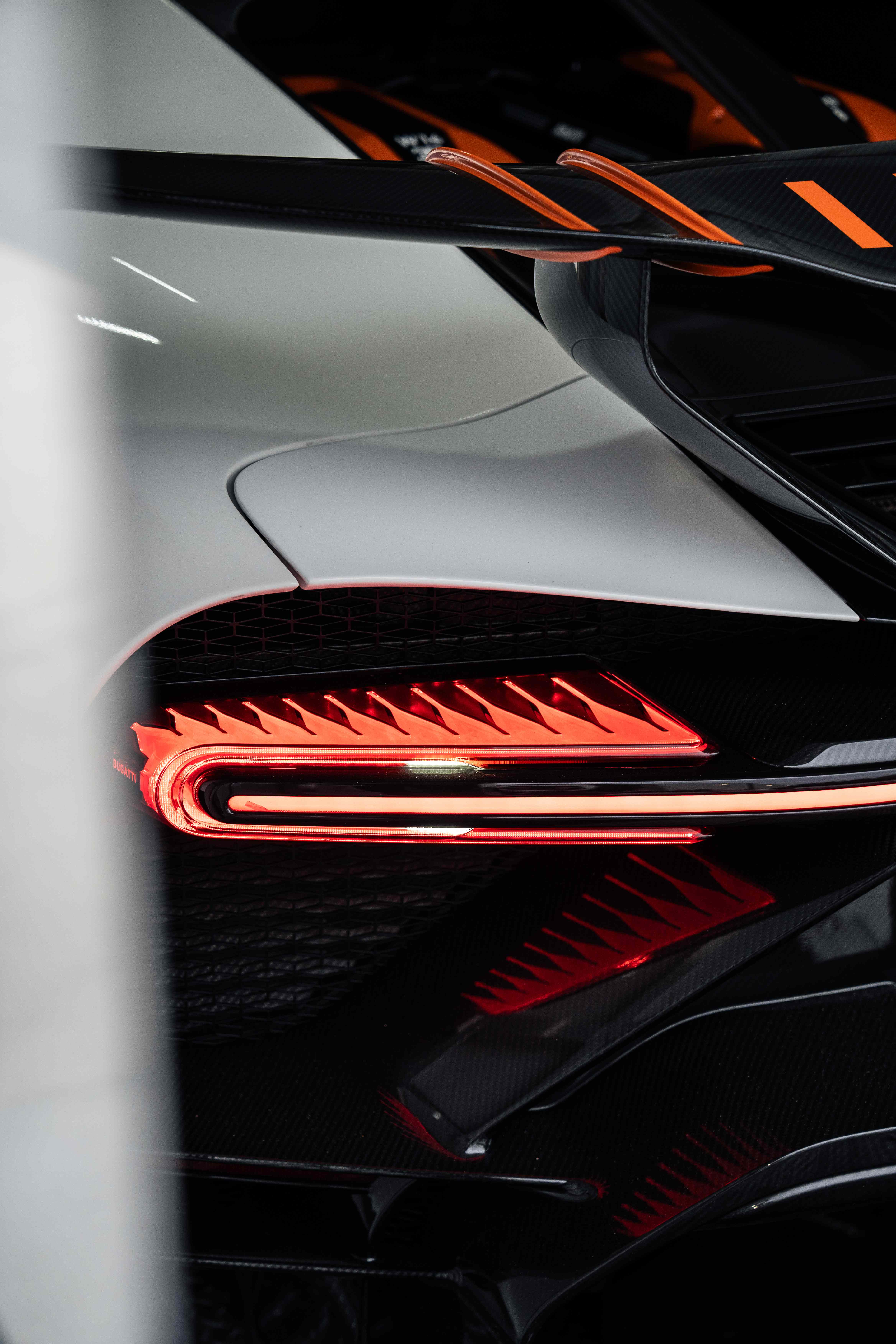 Bugatti Chiron Super Sport rear tail light detail — sawtooth LED cluster glowing red
