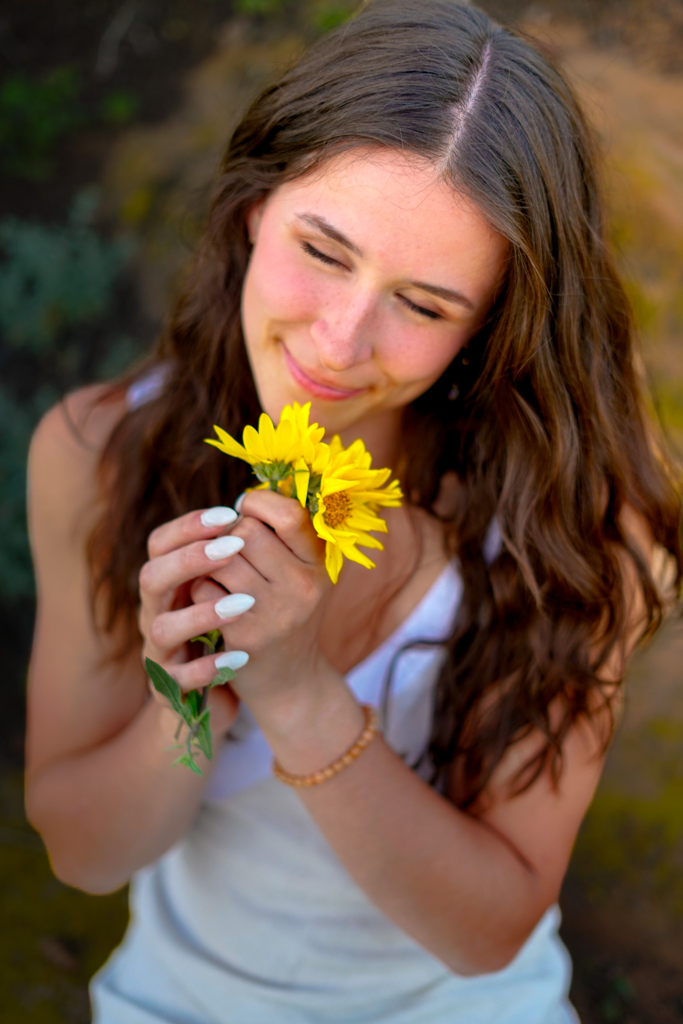 Senior portrait - brunette holding yellow sunflowers