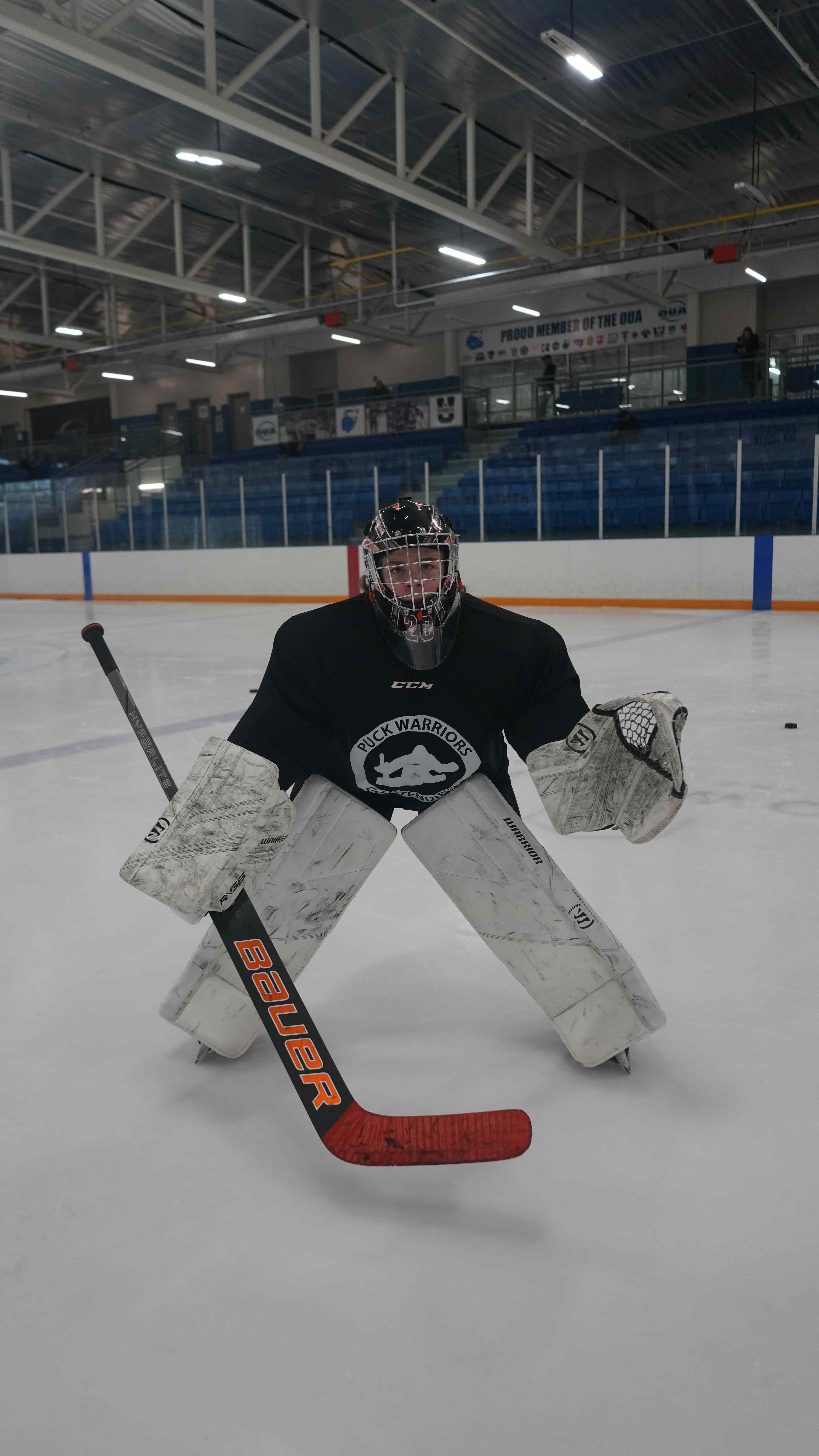 Goalie set in a ready stance tracking the puck