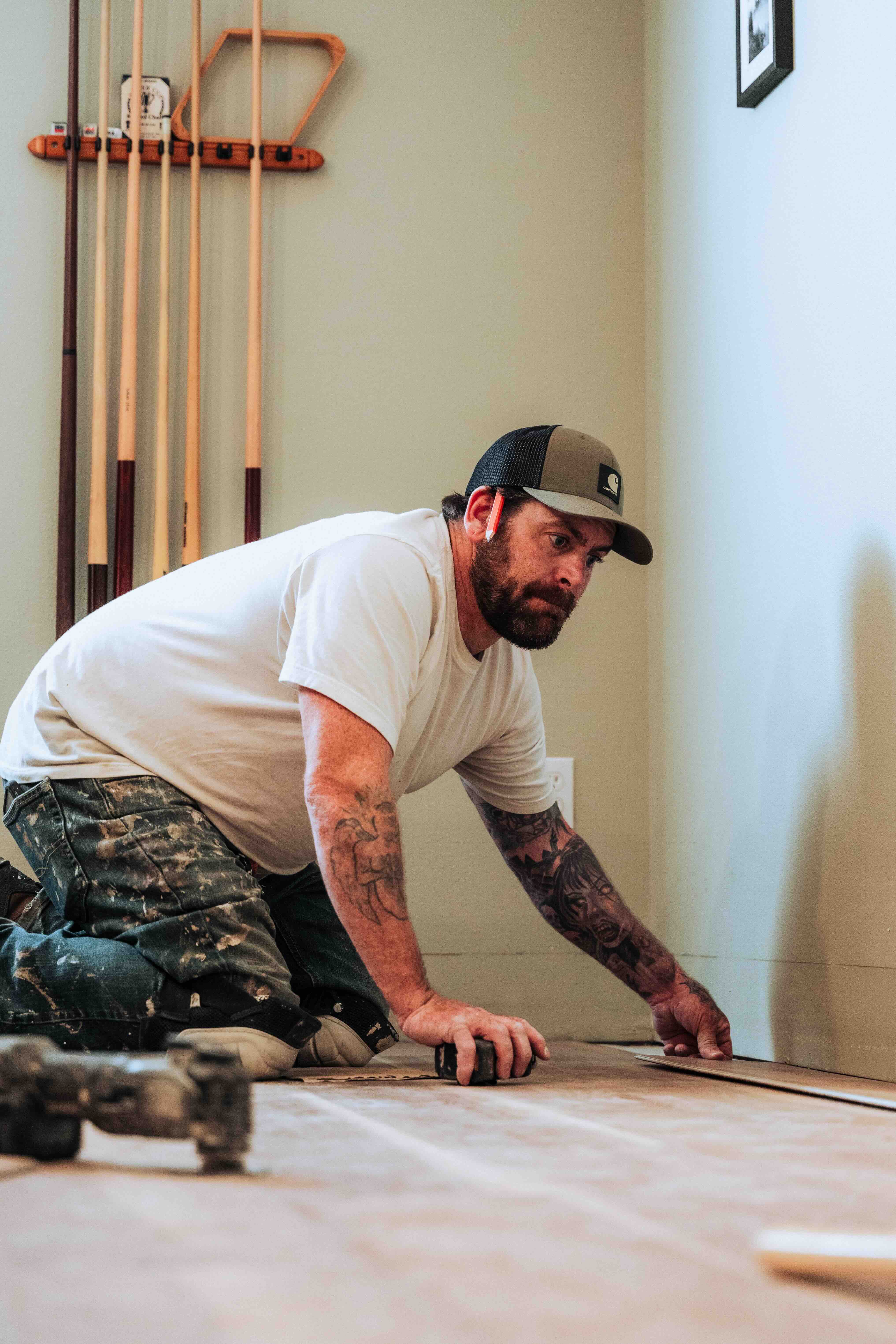 Contractor social media content - flooring crew installing wood planks with vacuum