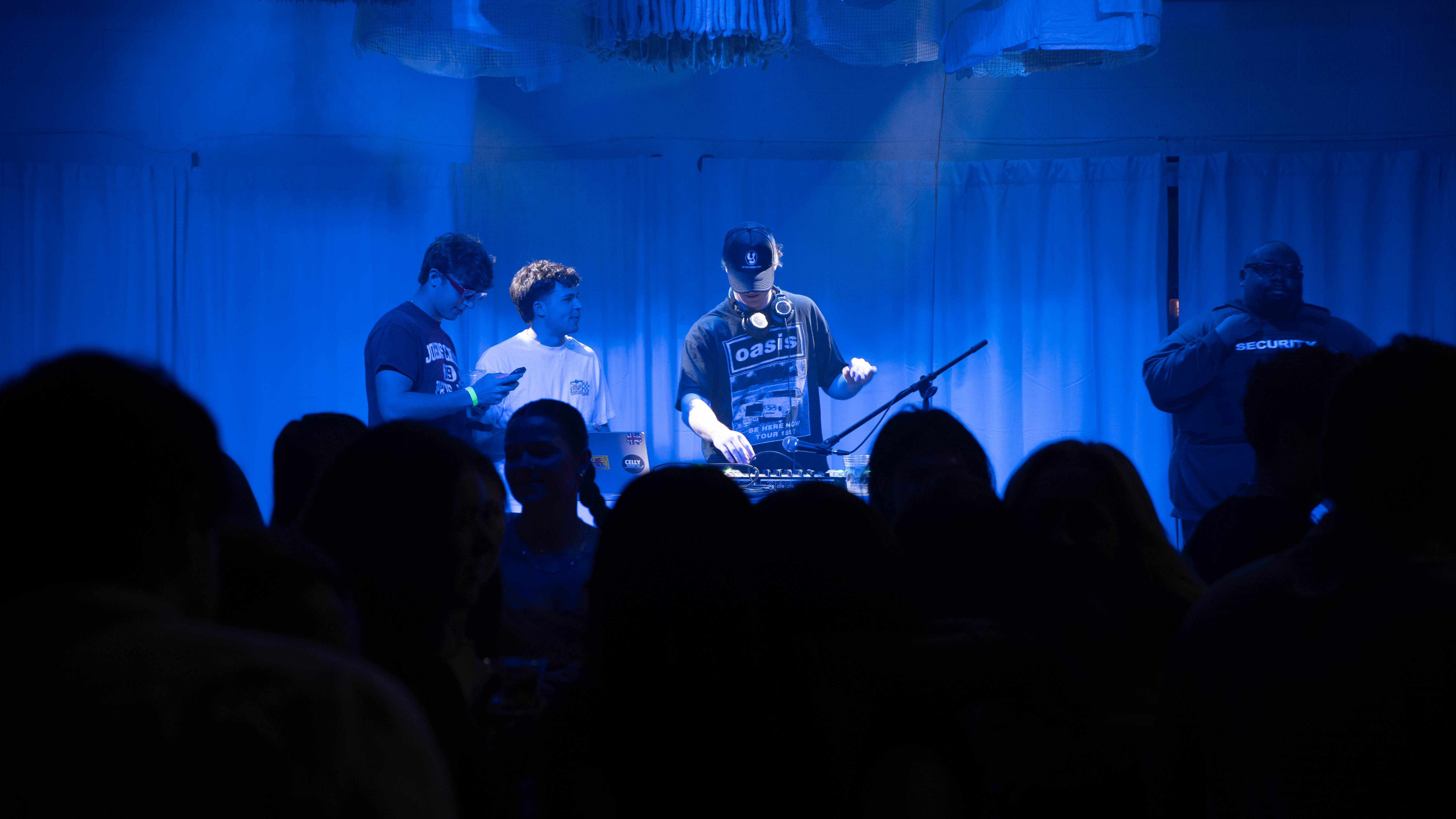 DJ performing under blue stage lighting