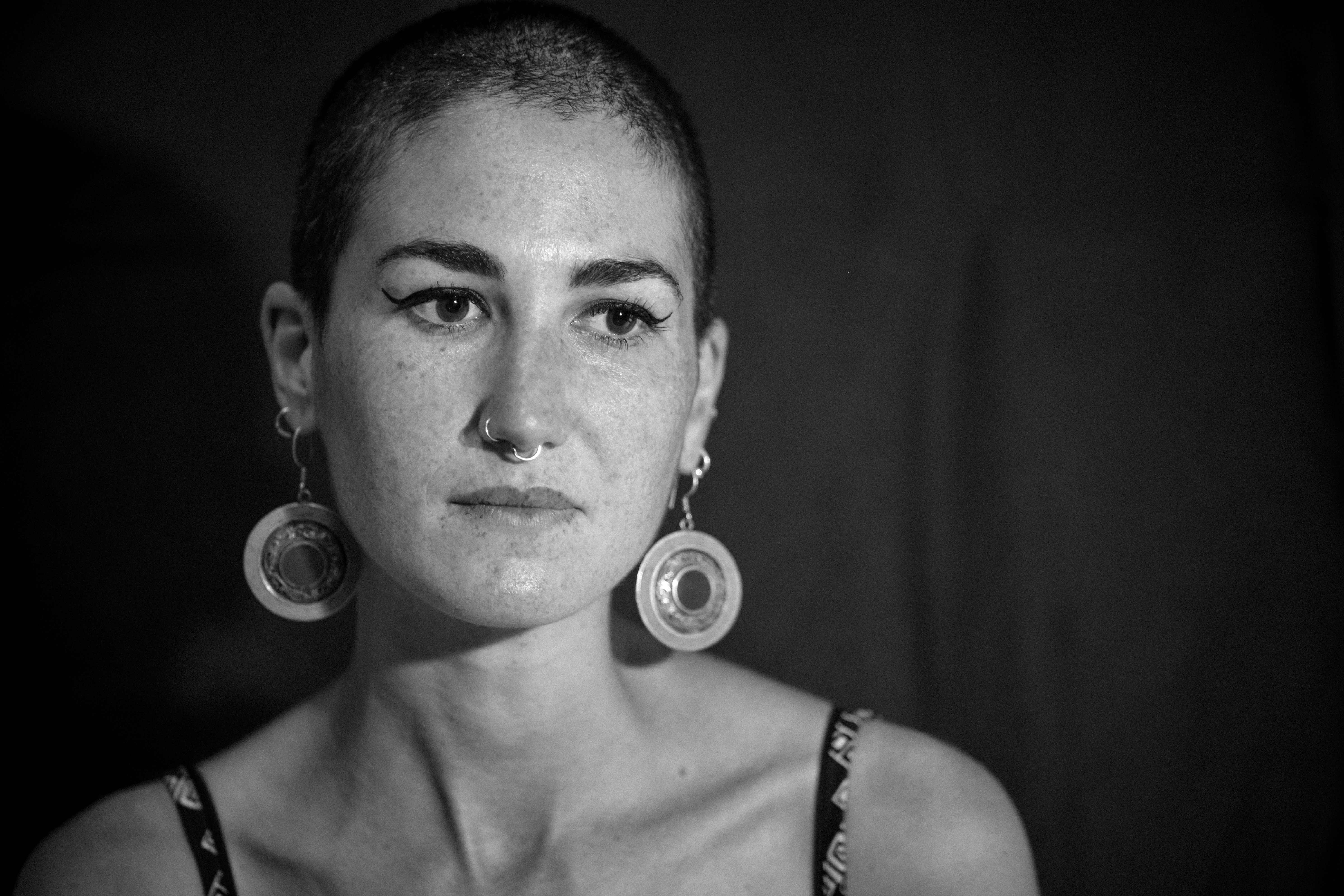Woman with shaved head serious expression