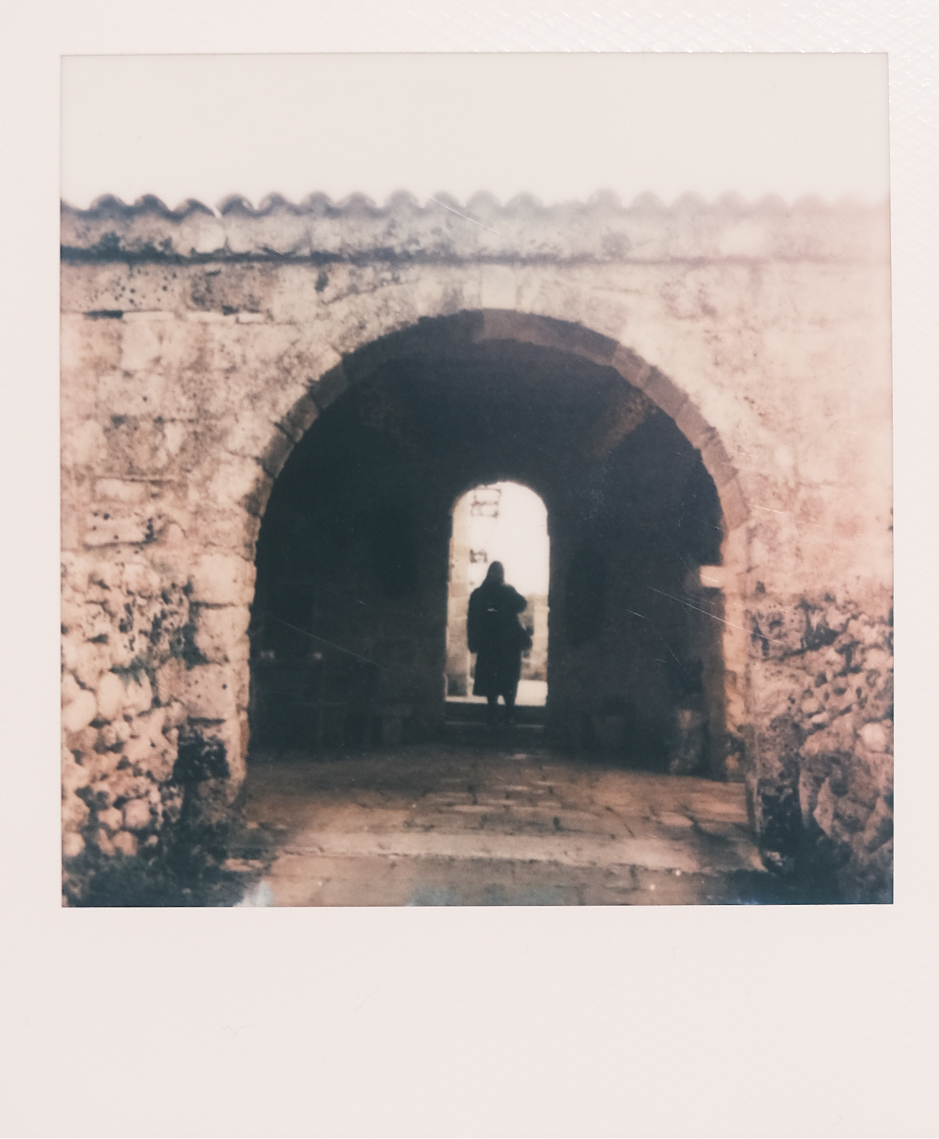 Silhouette in a stone archway