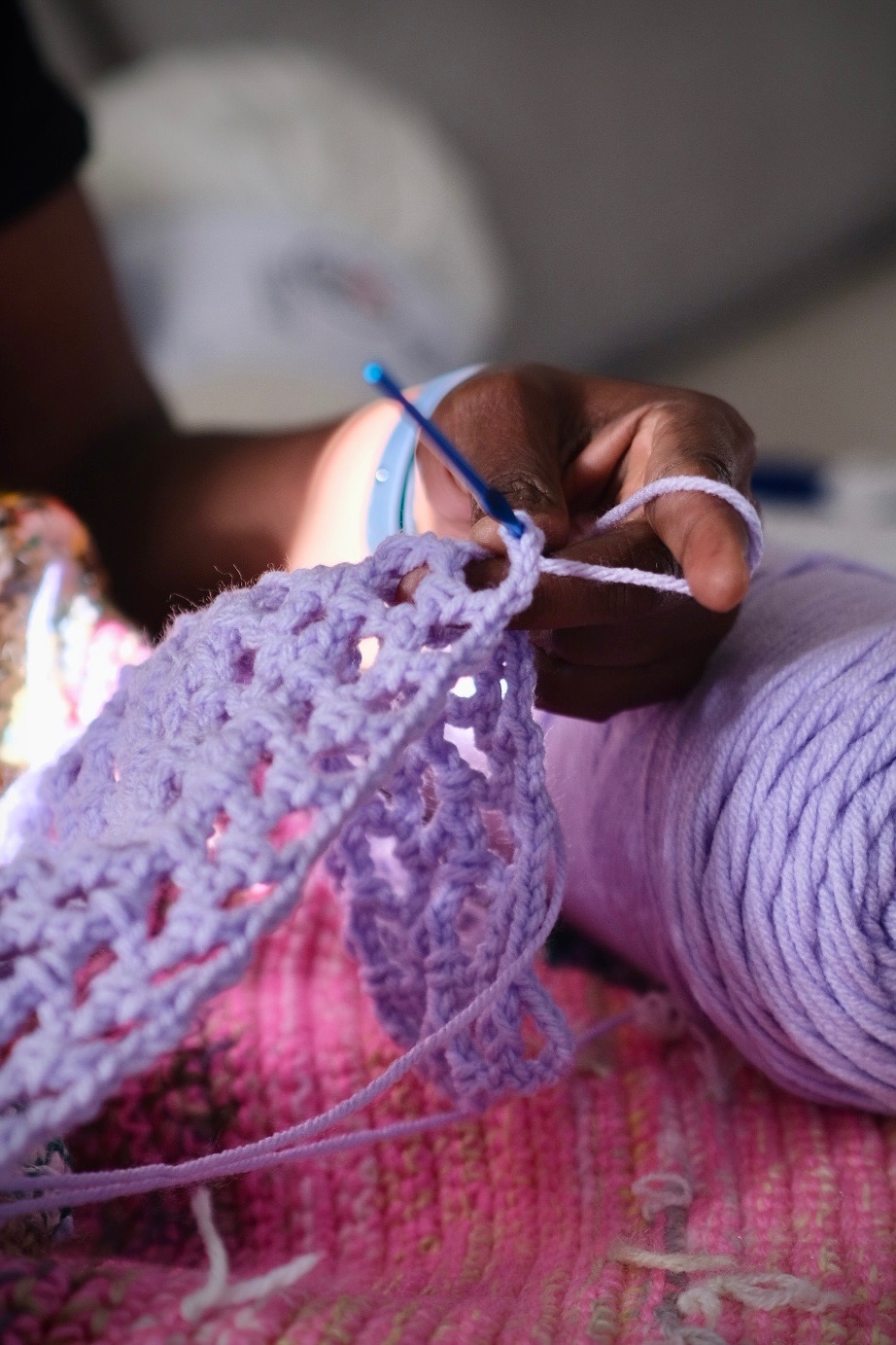 Close-up detail of crochet hook and yarn stitches