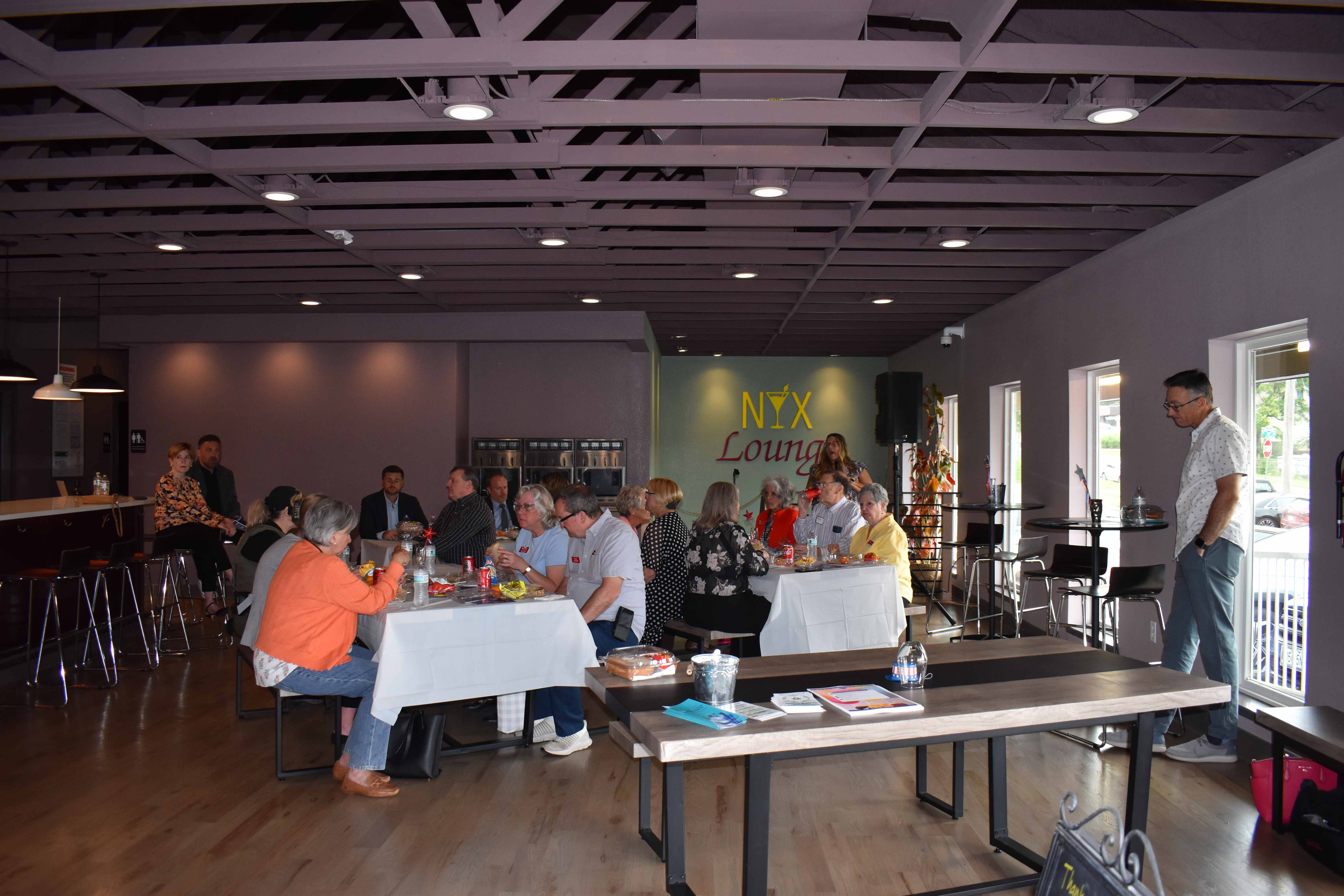 Guests gathered together for a hosted event on the NYX main floor with the NYX lounge signage visible