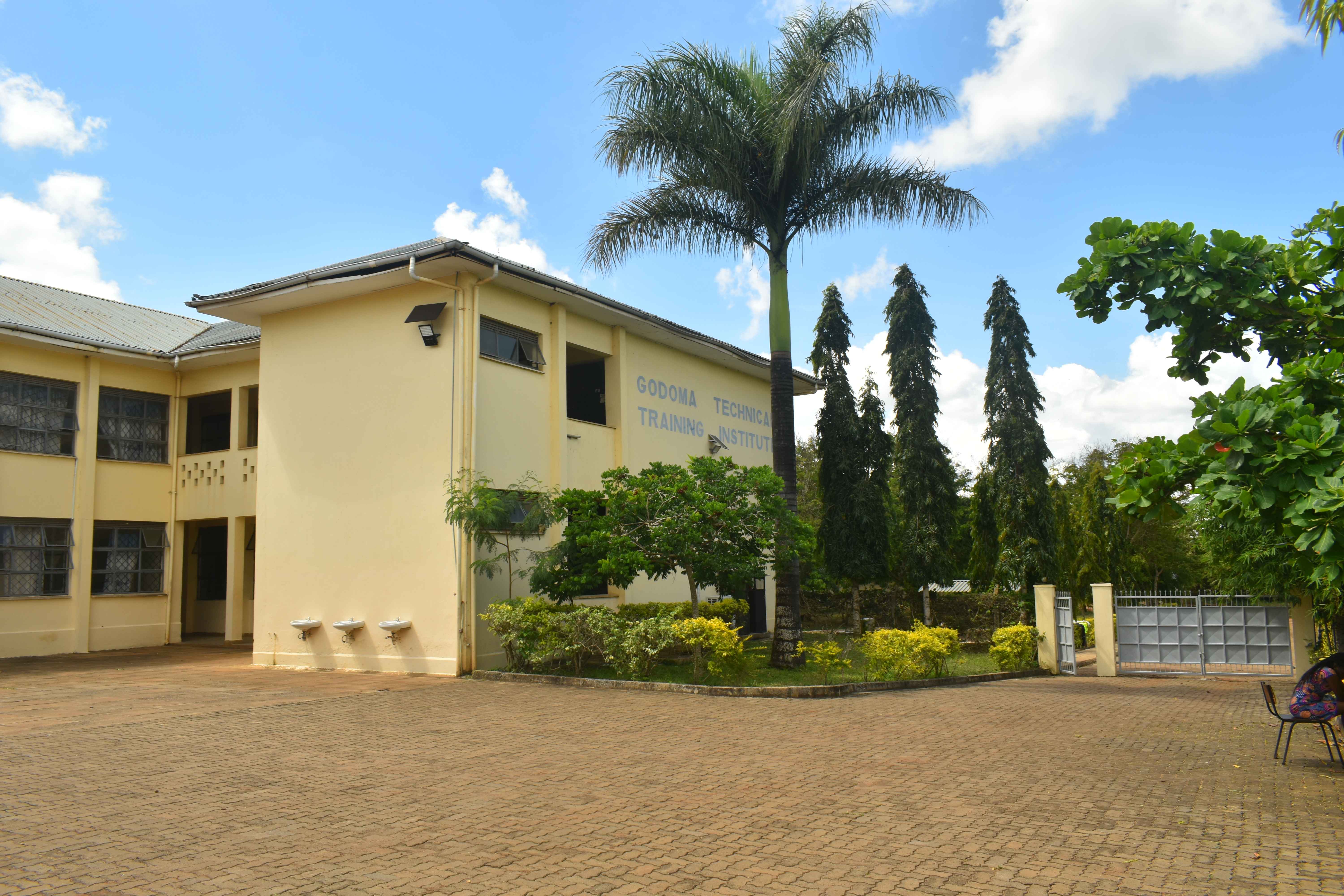 Godoma TTI campus courtyard with landscaped grounds and mature trees