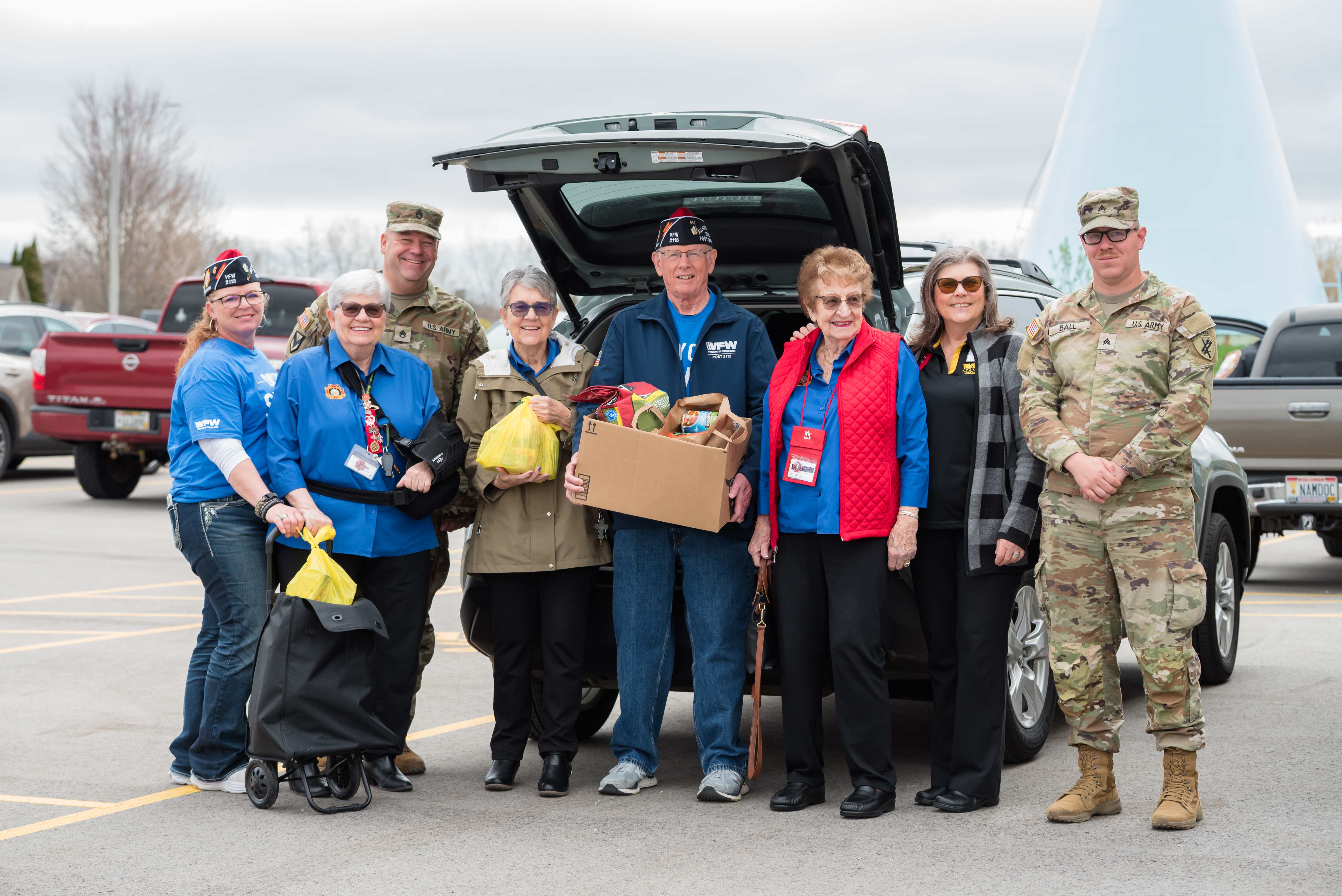 VFW volunteers and Army soldiers loading supplies into a vehicle at a community donation event