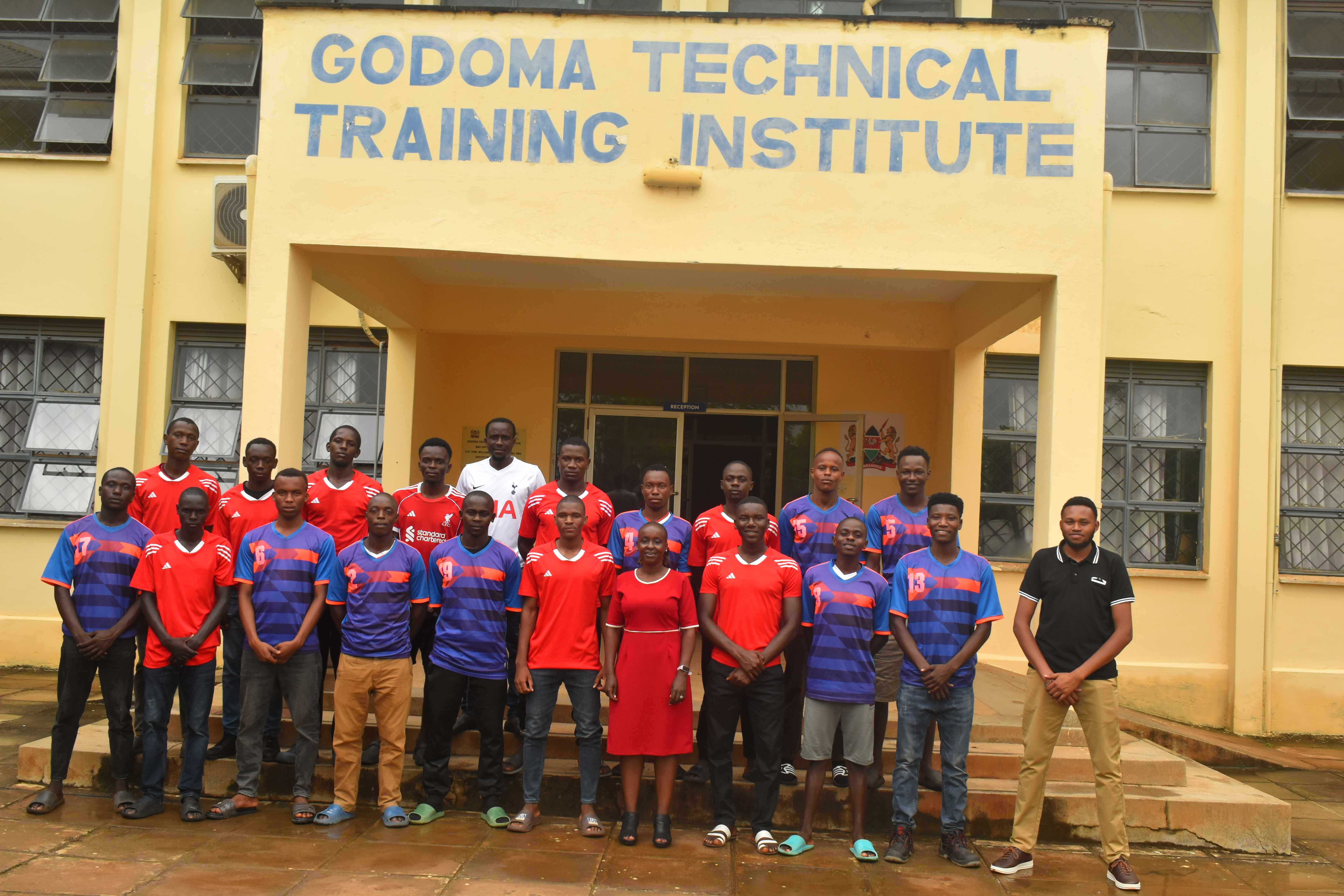 Godoma TTI football team pictured with the Principal outside the institute entrance