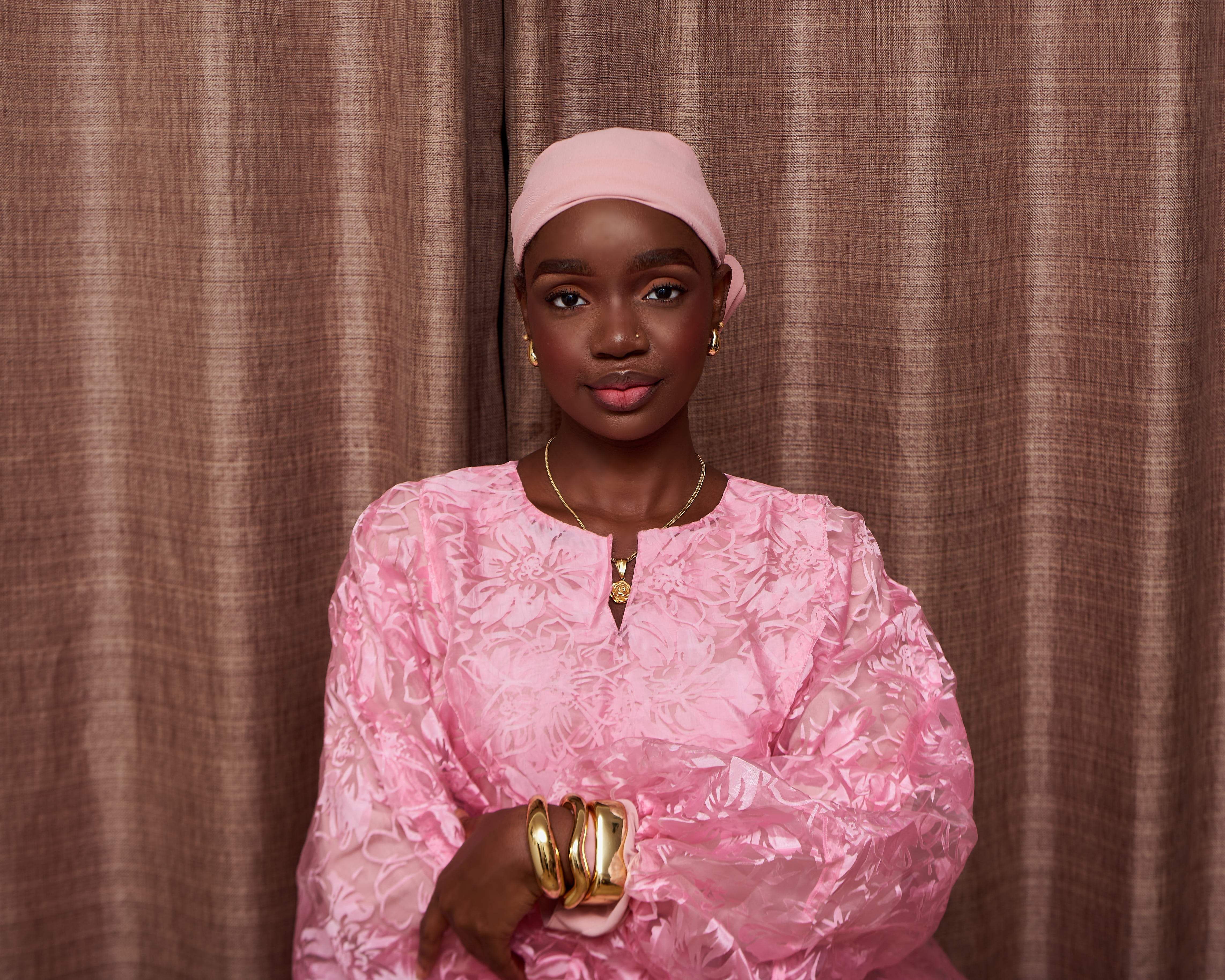 Suliat in a pink floral dress
