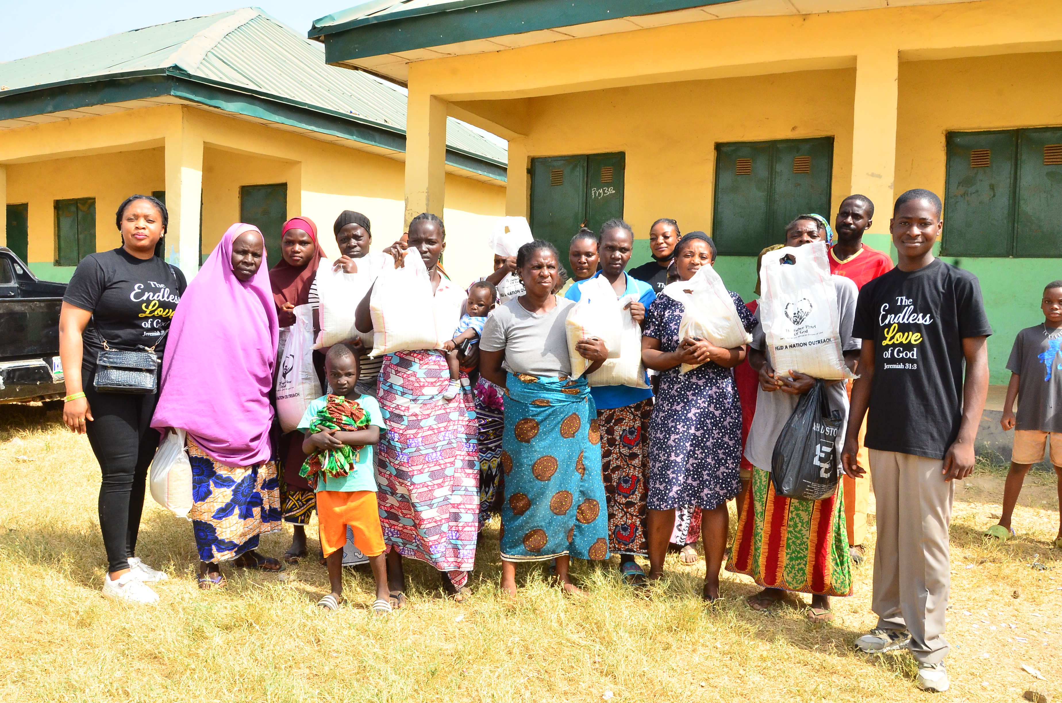 Group of women and children holding bags