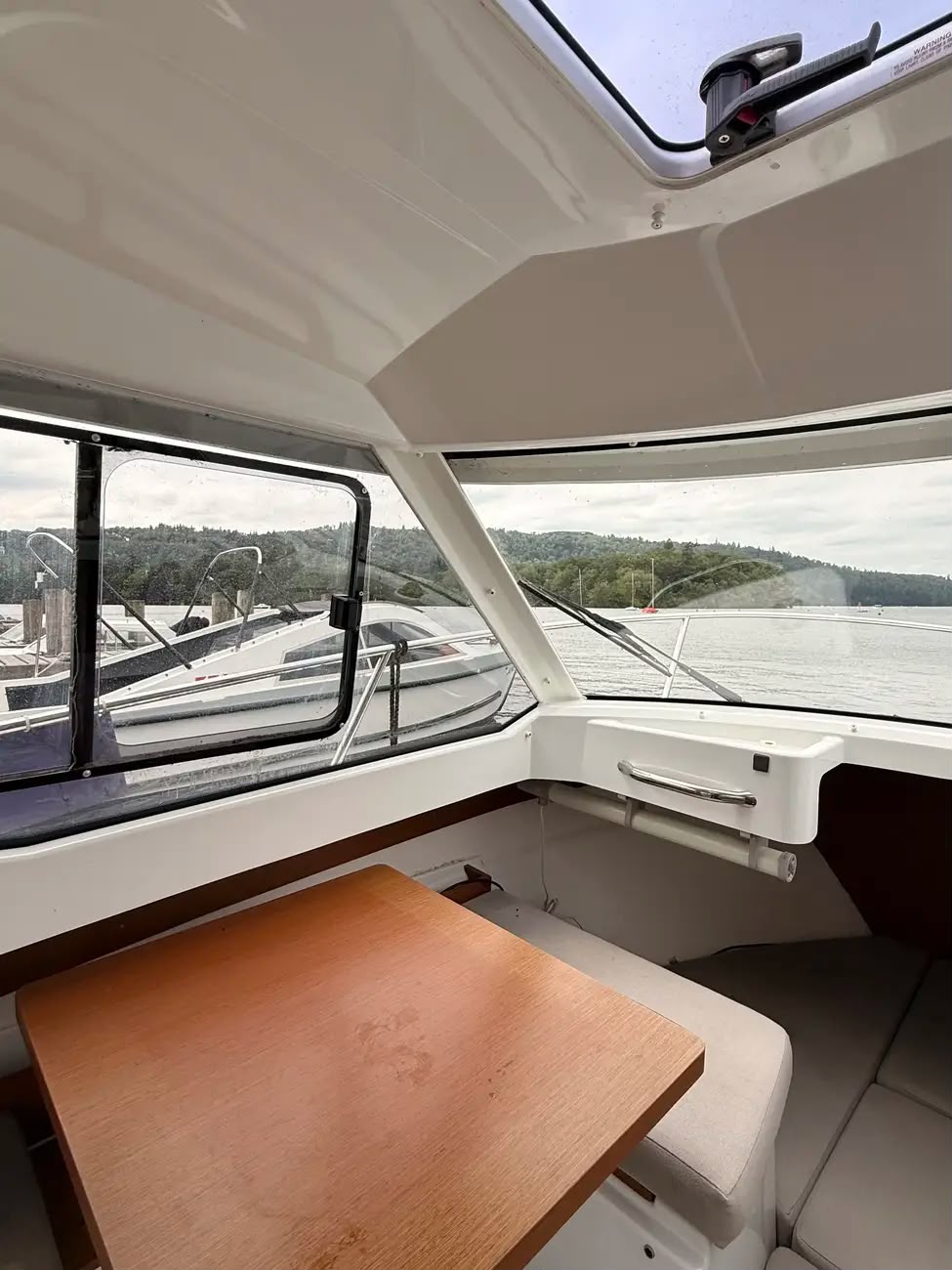 The dinette area with open side windows and views across Windermere