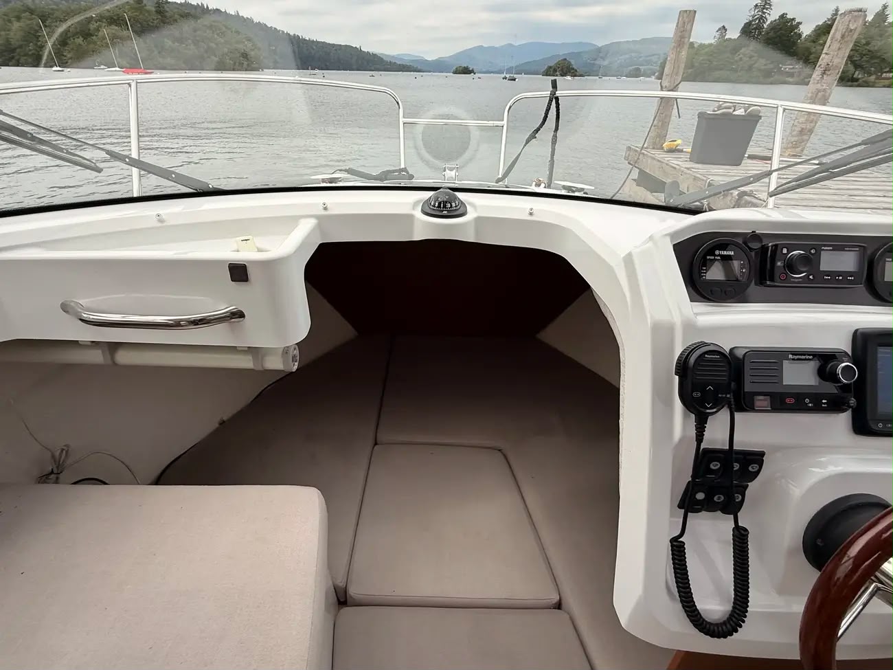 Wide cockpit view with the forward berth entrance and dashboard