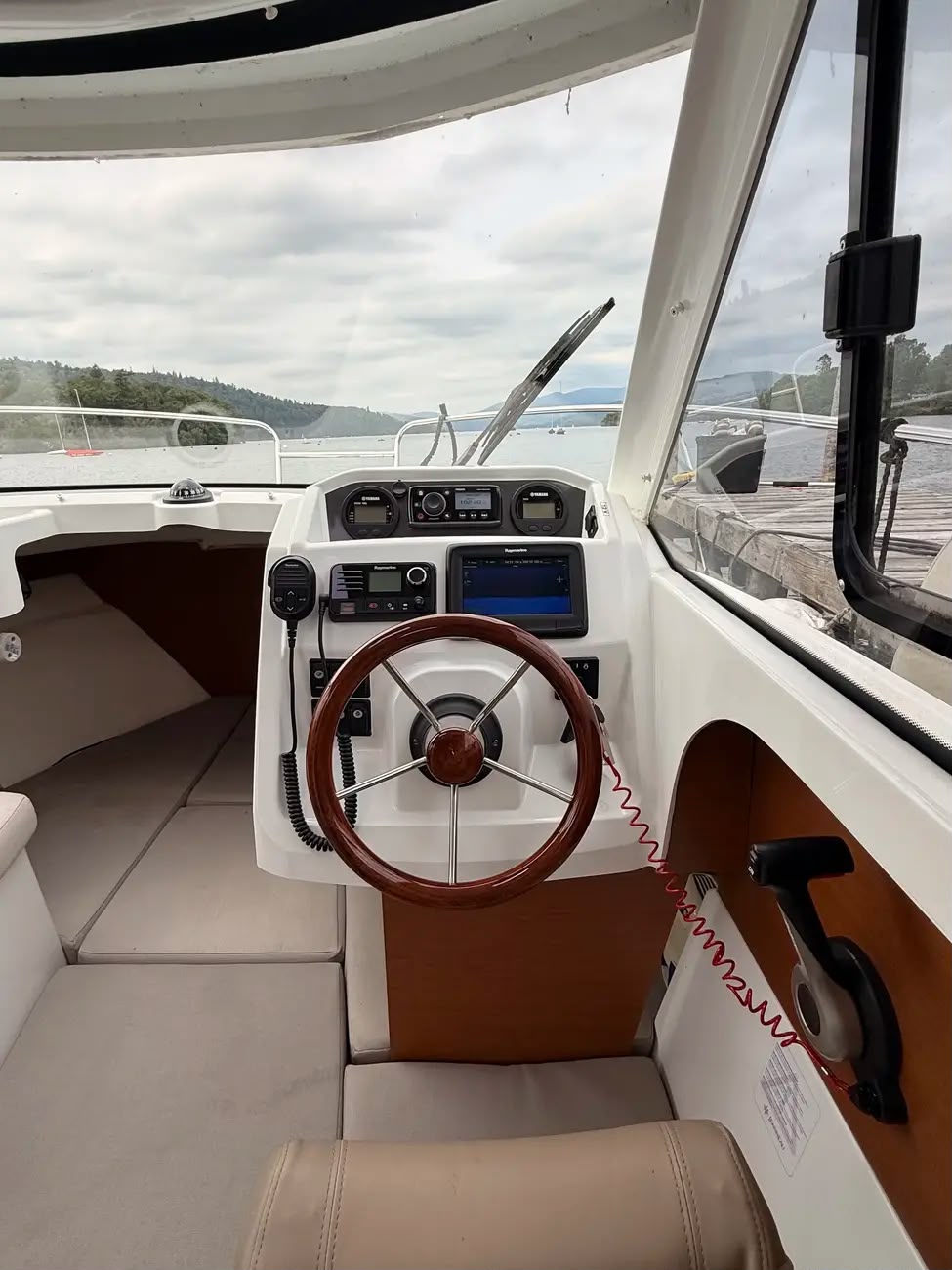 The helm viewed from the cabin with wheel and full electronics