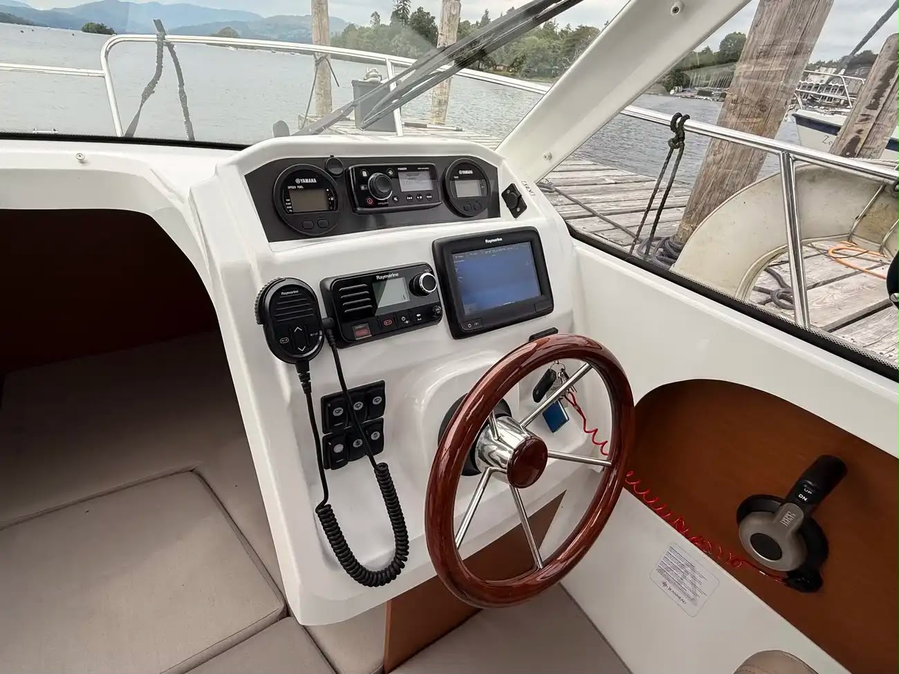 Close-up of the helm gauges and controls with a view over Windermere