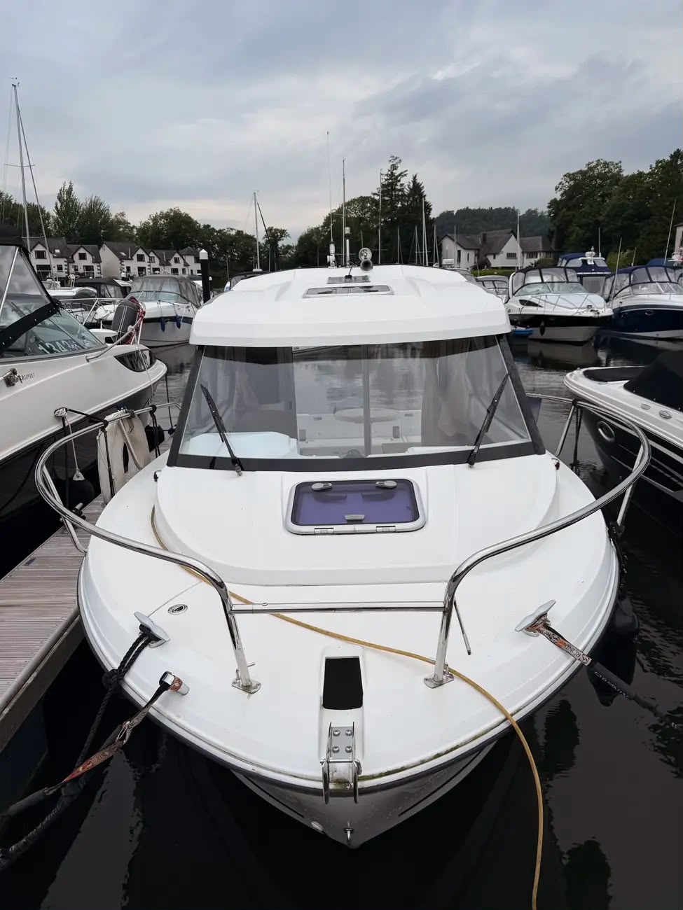 Bow-on view of the Merry Fisher 605 showing the enclosed wheelhouse and foredeck hatch