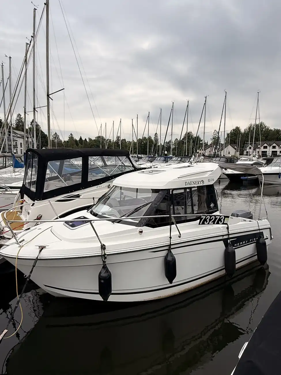 The Merry Fisher 605 moored among other boats in the marina