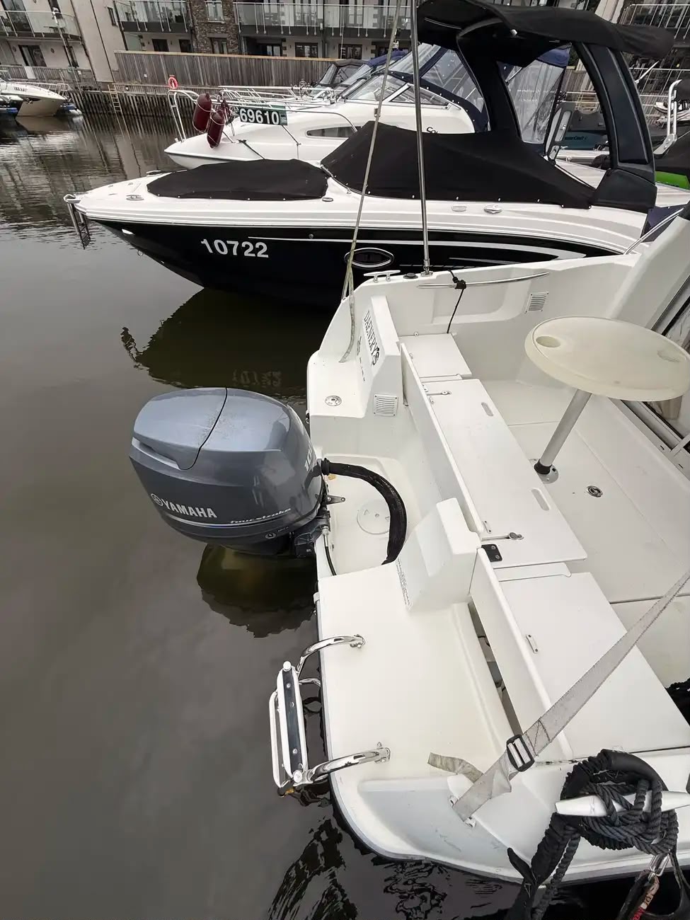 Stern quarter view showing the Yamaha four-stroke outboard and boarding ladder