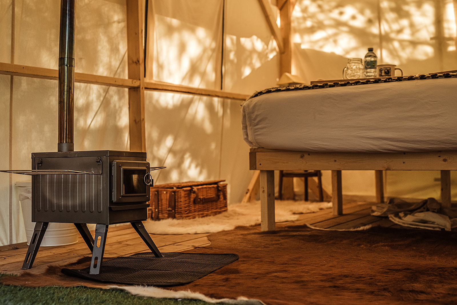 Cozy tent interior with wood stove
