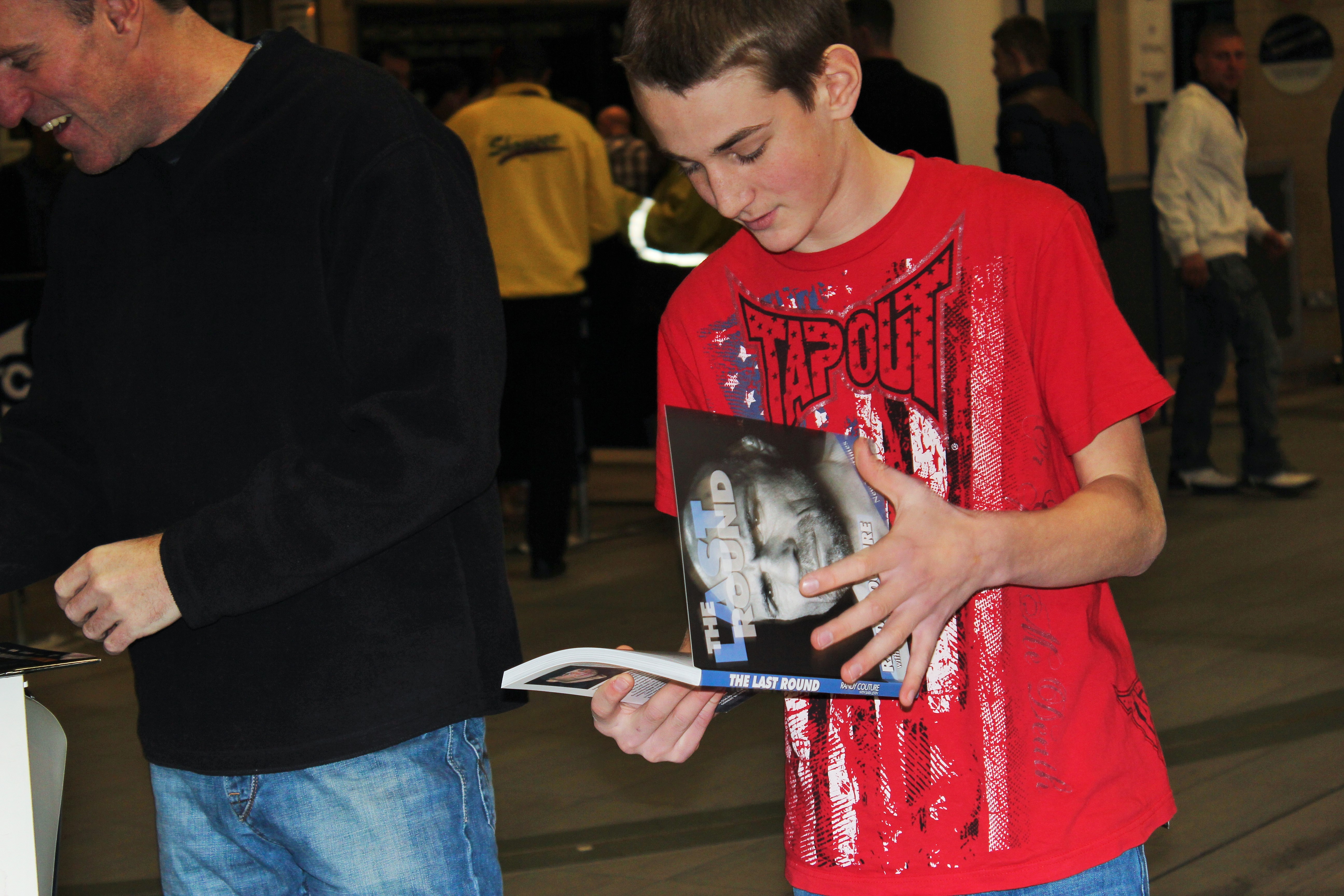 Young fan with signed Randy Couture book