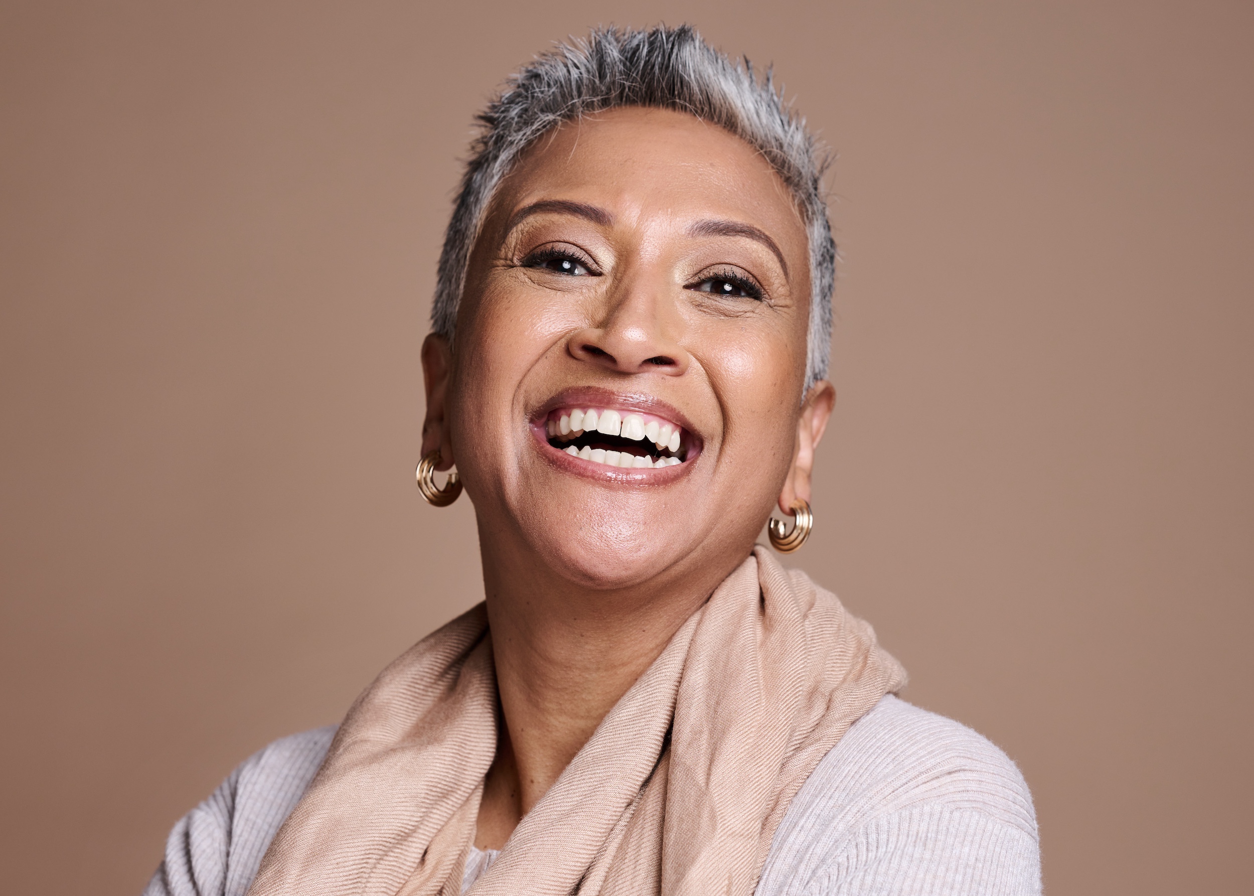 Happy patient with a beautiful smile after dental implant treatment