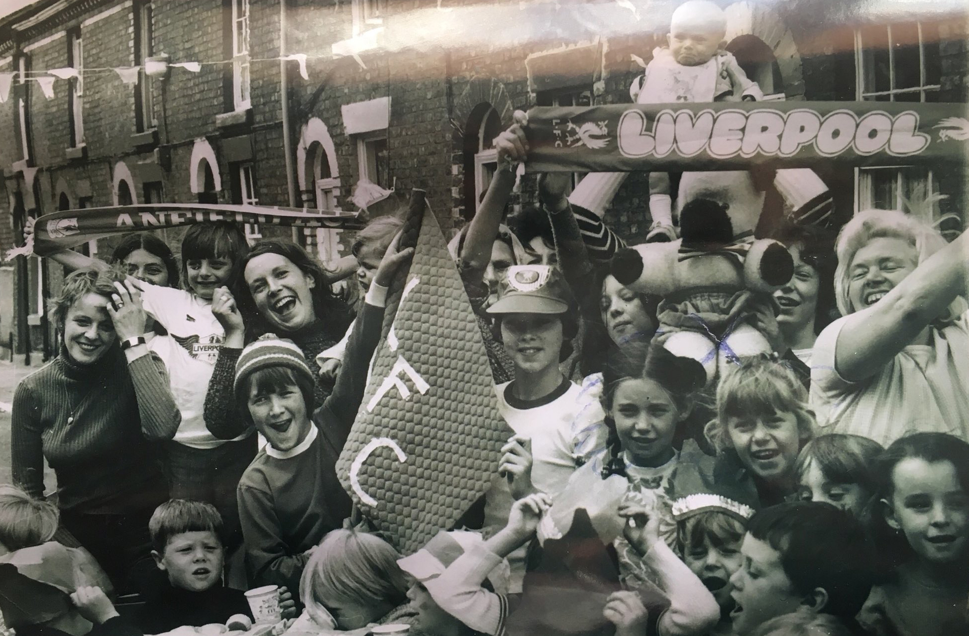 Fans celebrating outside terraced houses