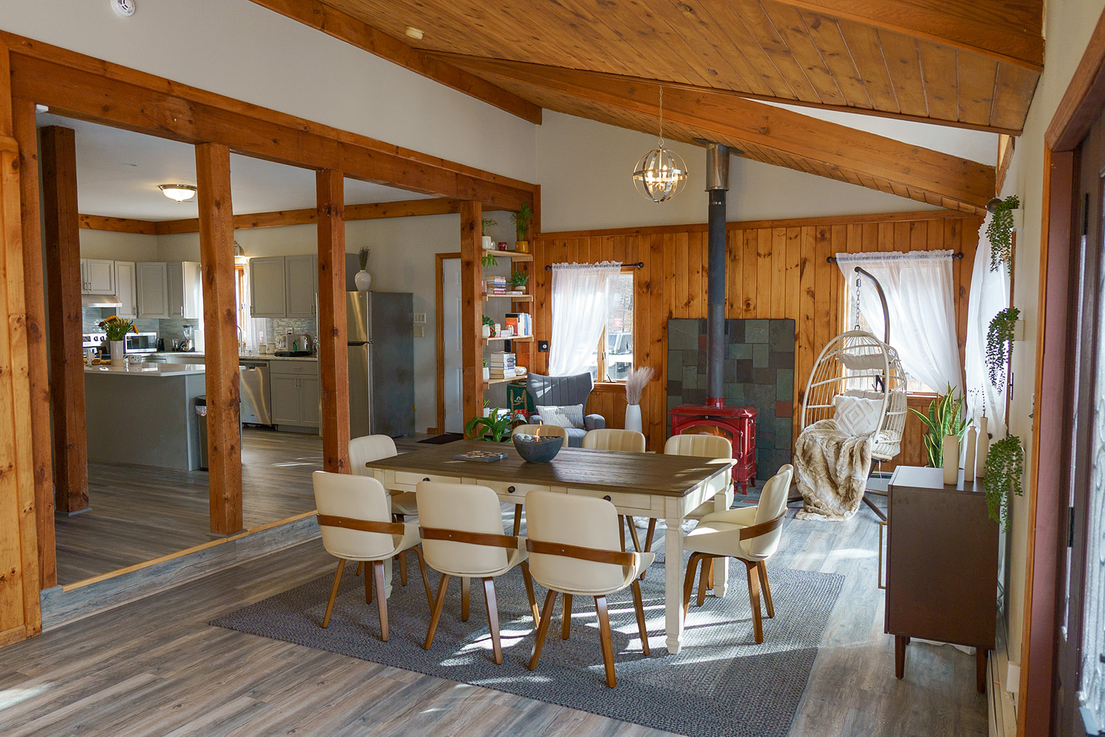 Dining area with wooden table and hanging egg chair