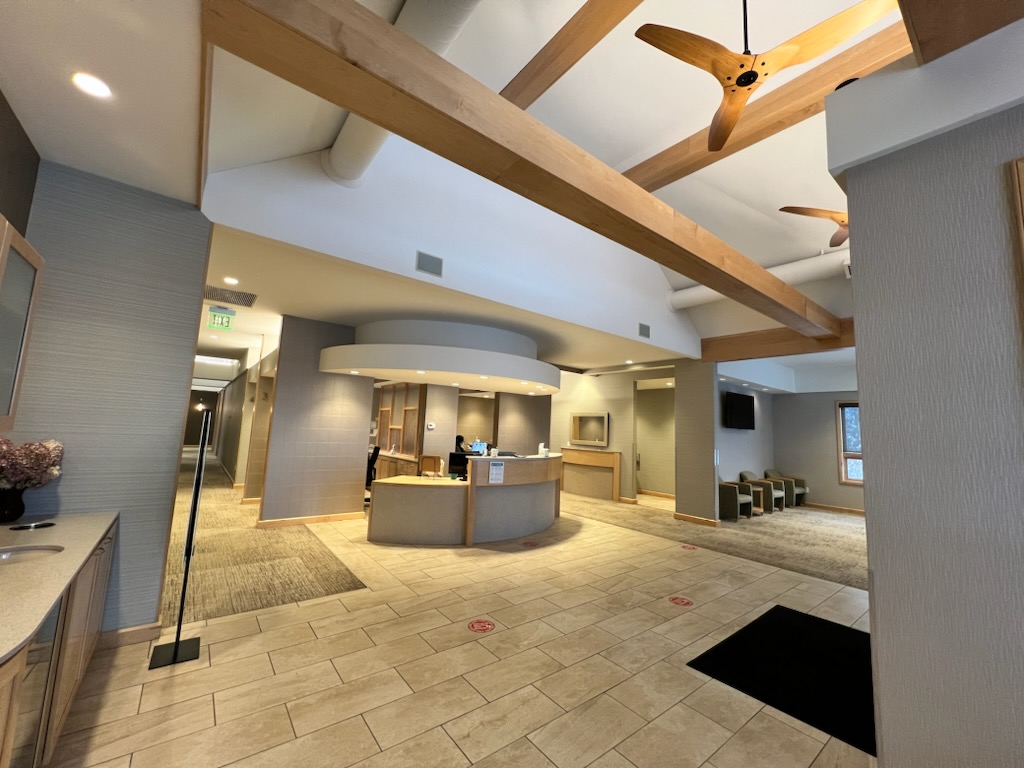 Welcoming Essex Family Dental reception with exposed timber beams and warm natural finishes