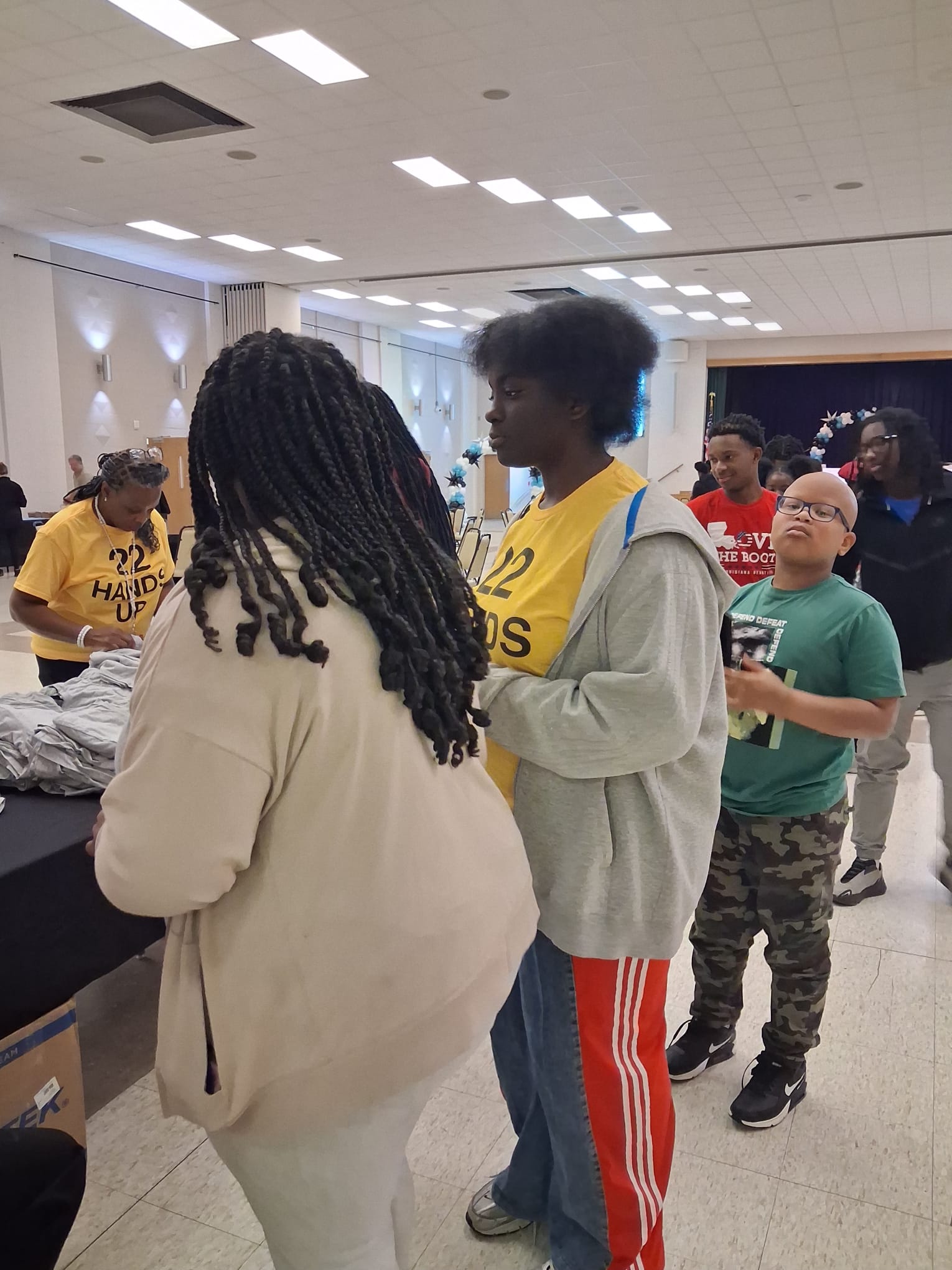 Volunteers handing out t-shirts and materials to youth participants