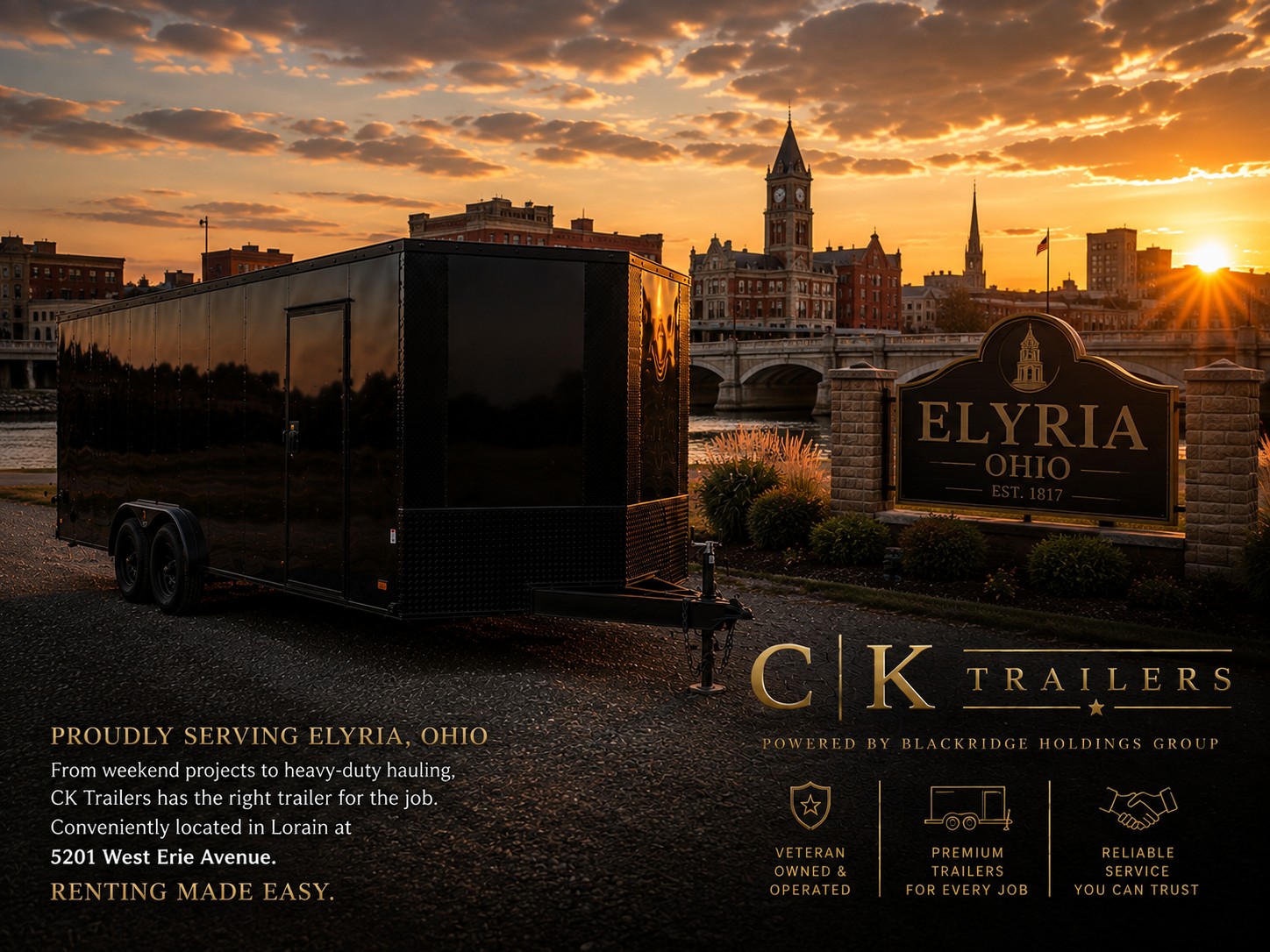 Black CK Trailers enclosed trailer parked near the Elyria Ohio Est. 1817 sign with the historic clock tower and riverfront skyline at sunset