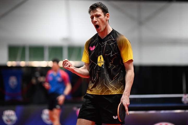 Enzo Angles reacting after winning a point in Major League Table Tennis, racket in hand