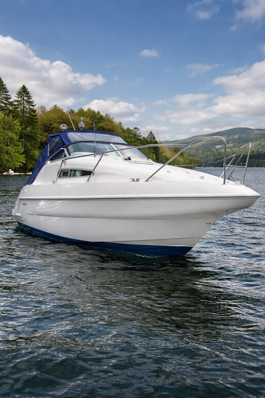 The Sealine 240S moored on Lake Windermere with its blue canopy and the fells behind