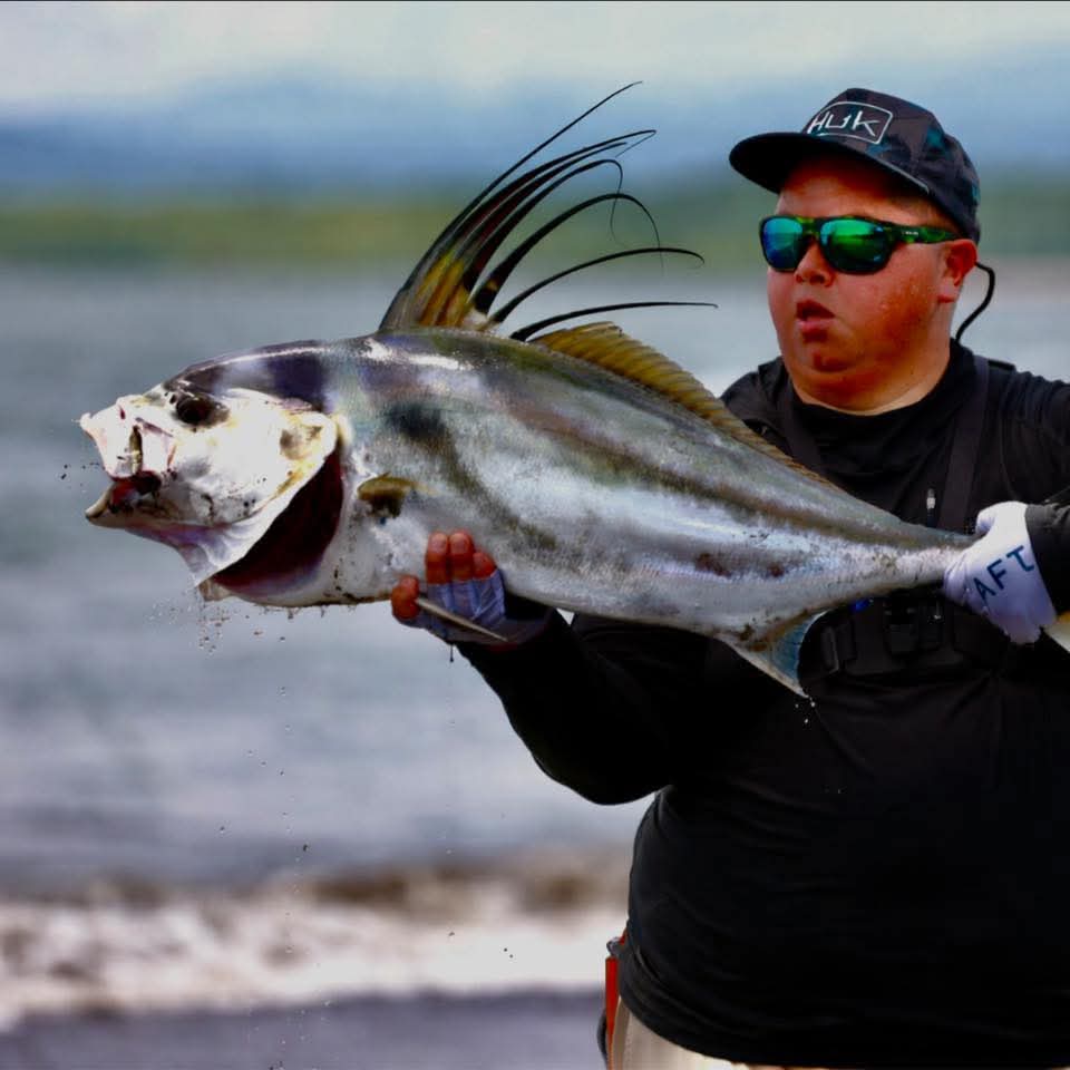 Pescador sosteniendo un gran pez