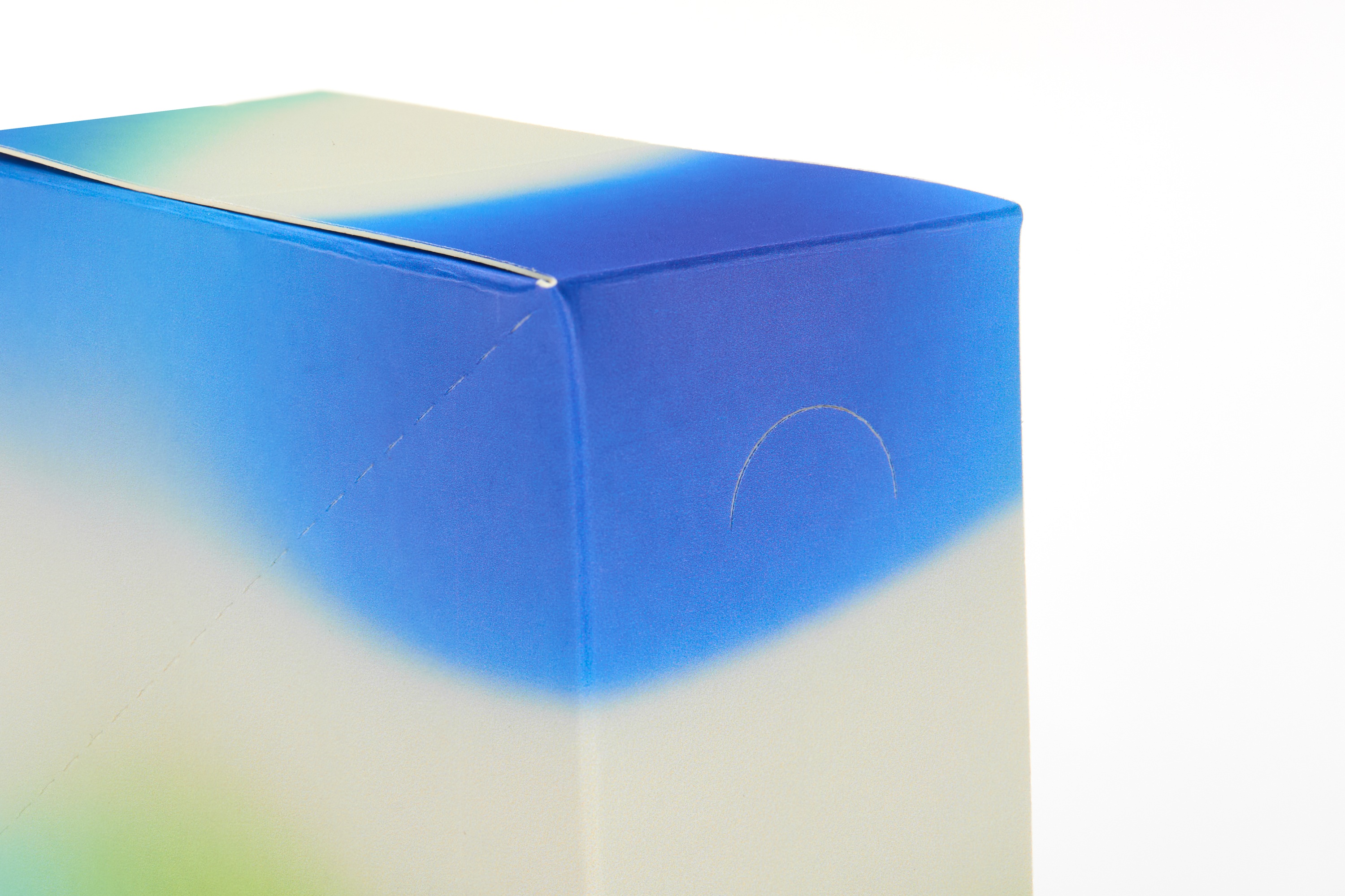 Close-up of gradient battery box showing perforated thumb tab opening mechanism