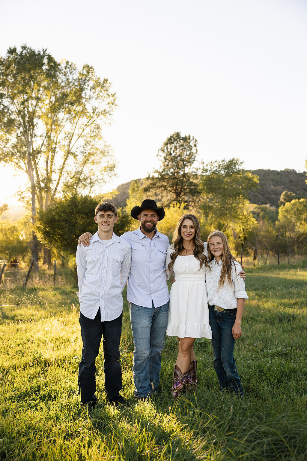 The Black family together in a sunlit meadow at L-J Ranch