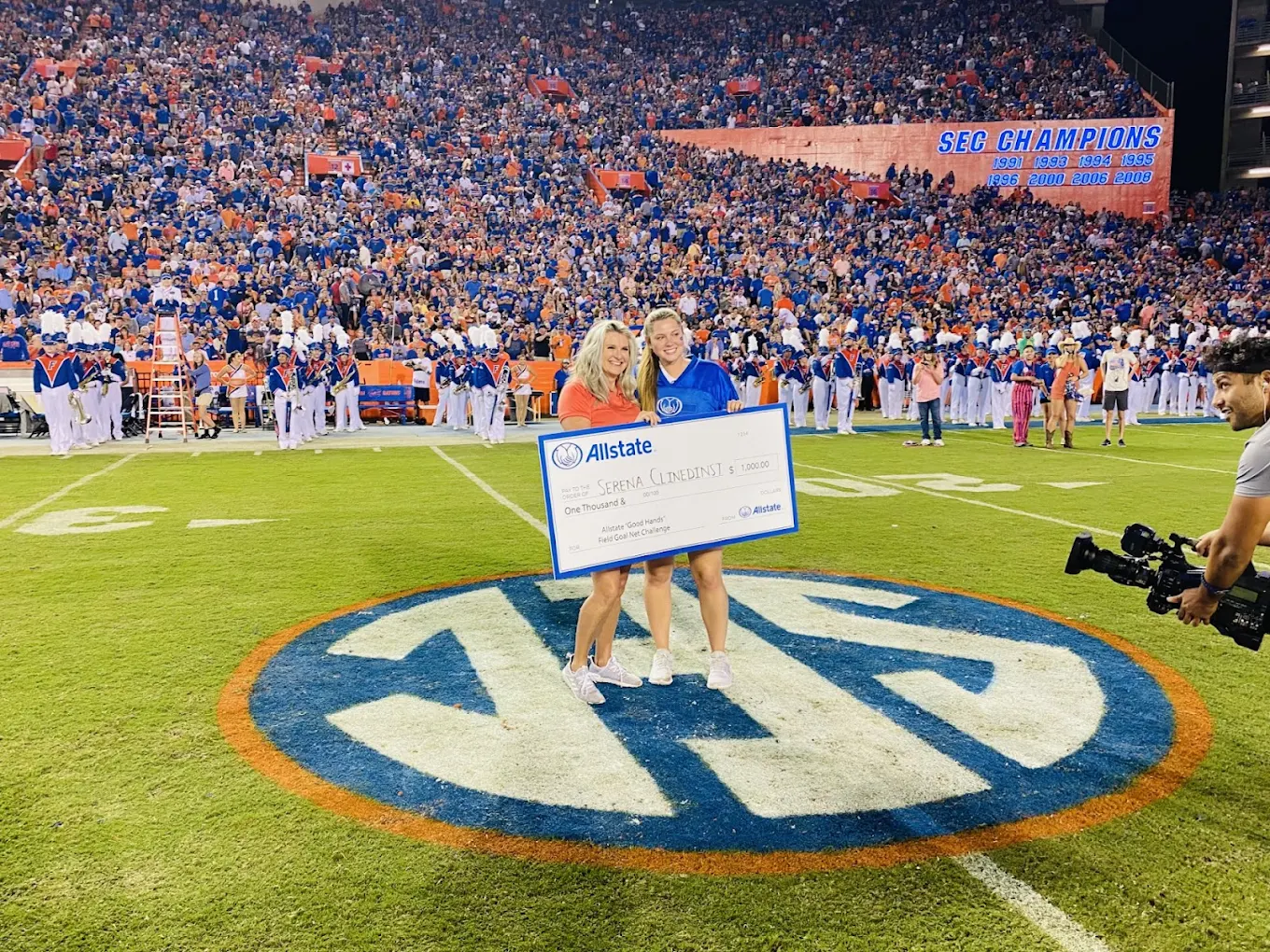 Team members at the stadium with Allstate check