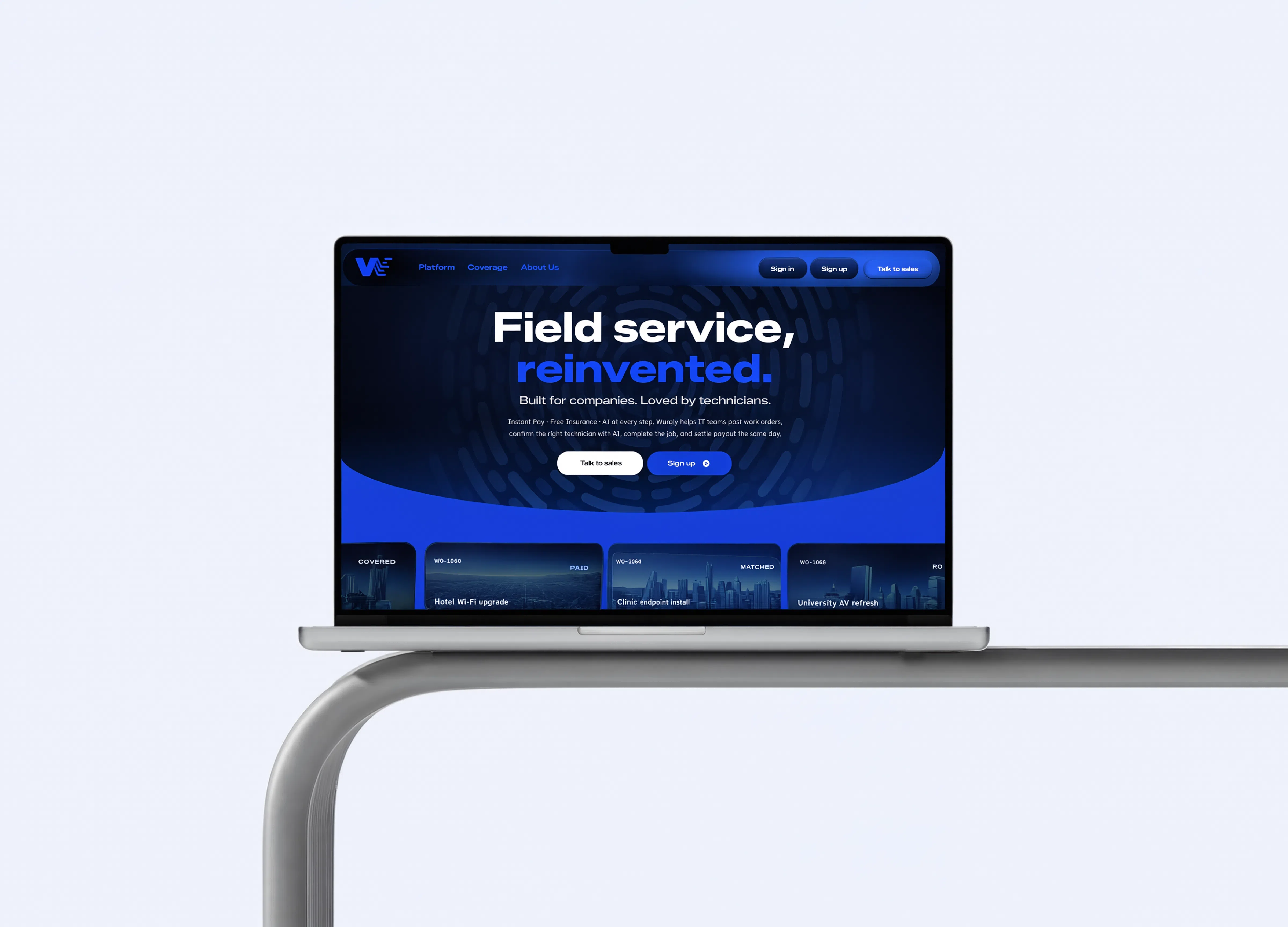 Wurqly’s navy and blue website displayed on a laptop resting on a curved silver shelf.
