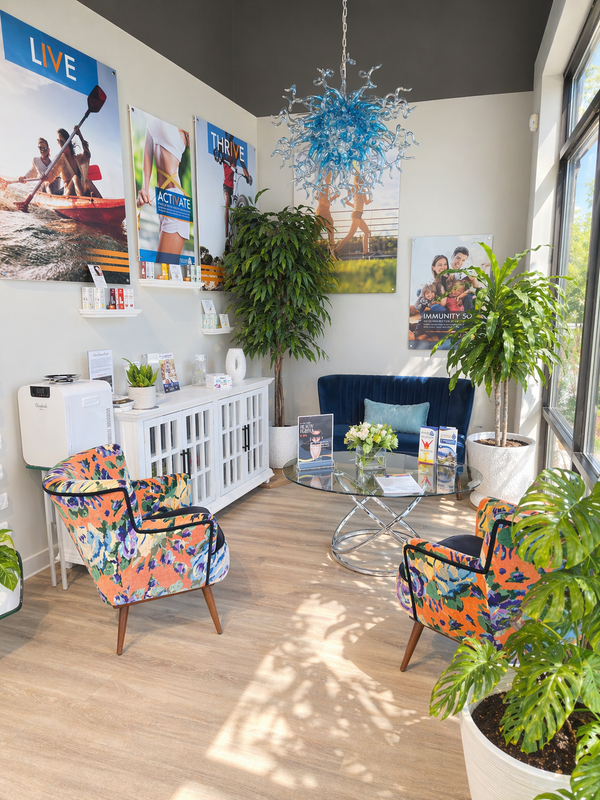 The bright Flemington reception lounge with floral chairs and a blue glass chandelier